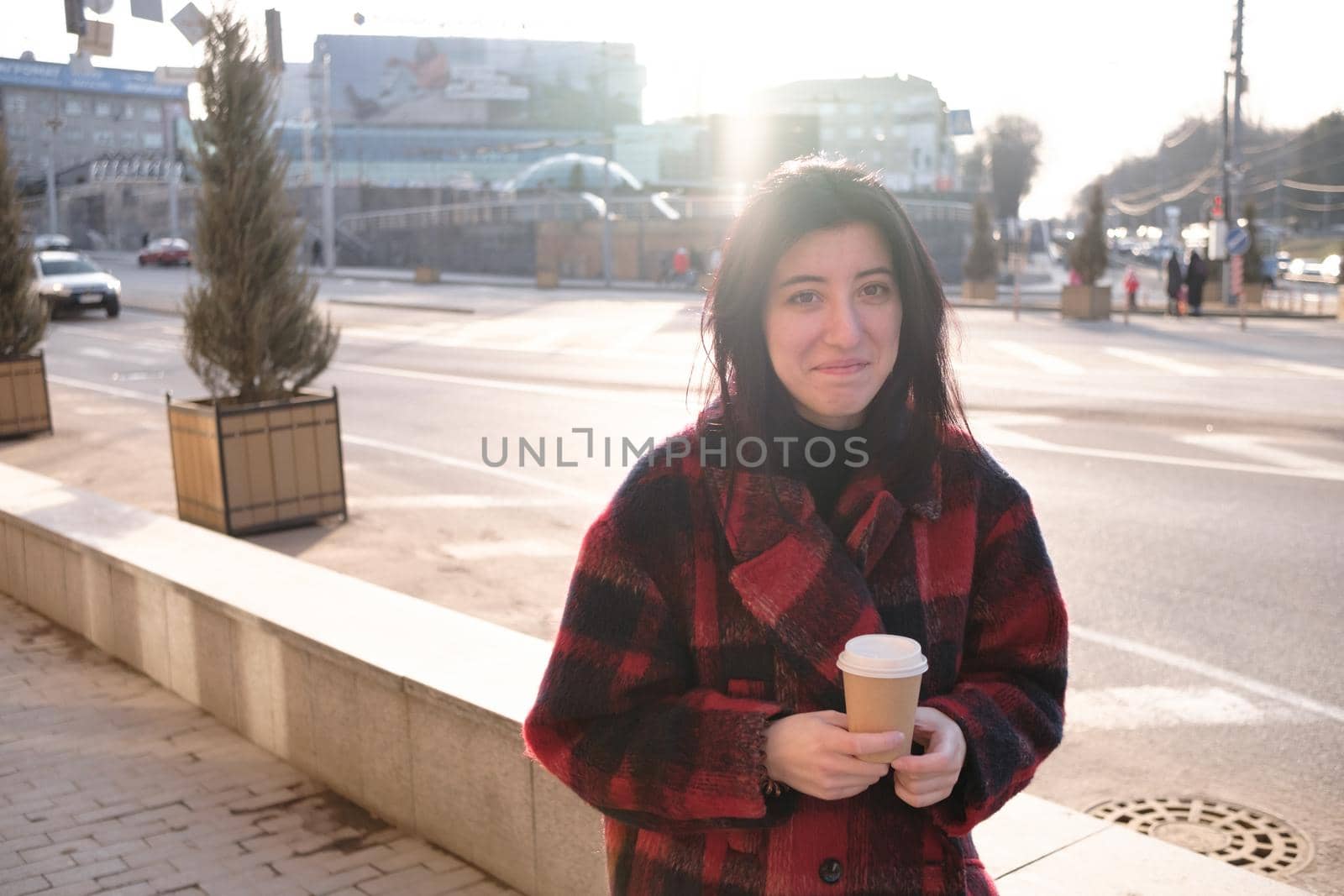 Woman drinking coffee in the sun, outdoor in sunlight light, enjoying her morning