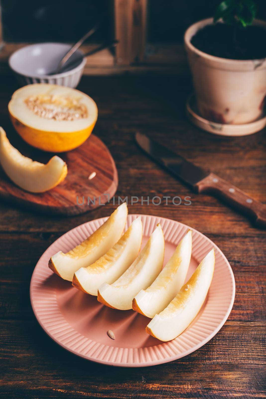 Sliced Sweet Yellow Melon on Plate over Wooden Surface