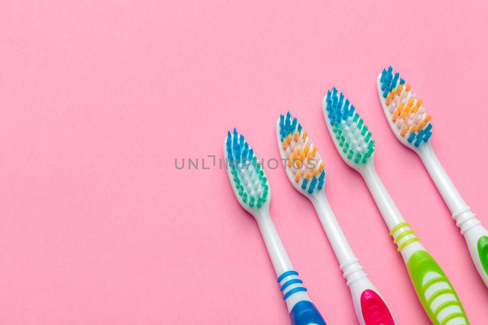 Toothbrushes on pink background. close up. creative photo. by Fabrikasimf