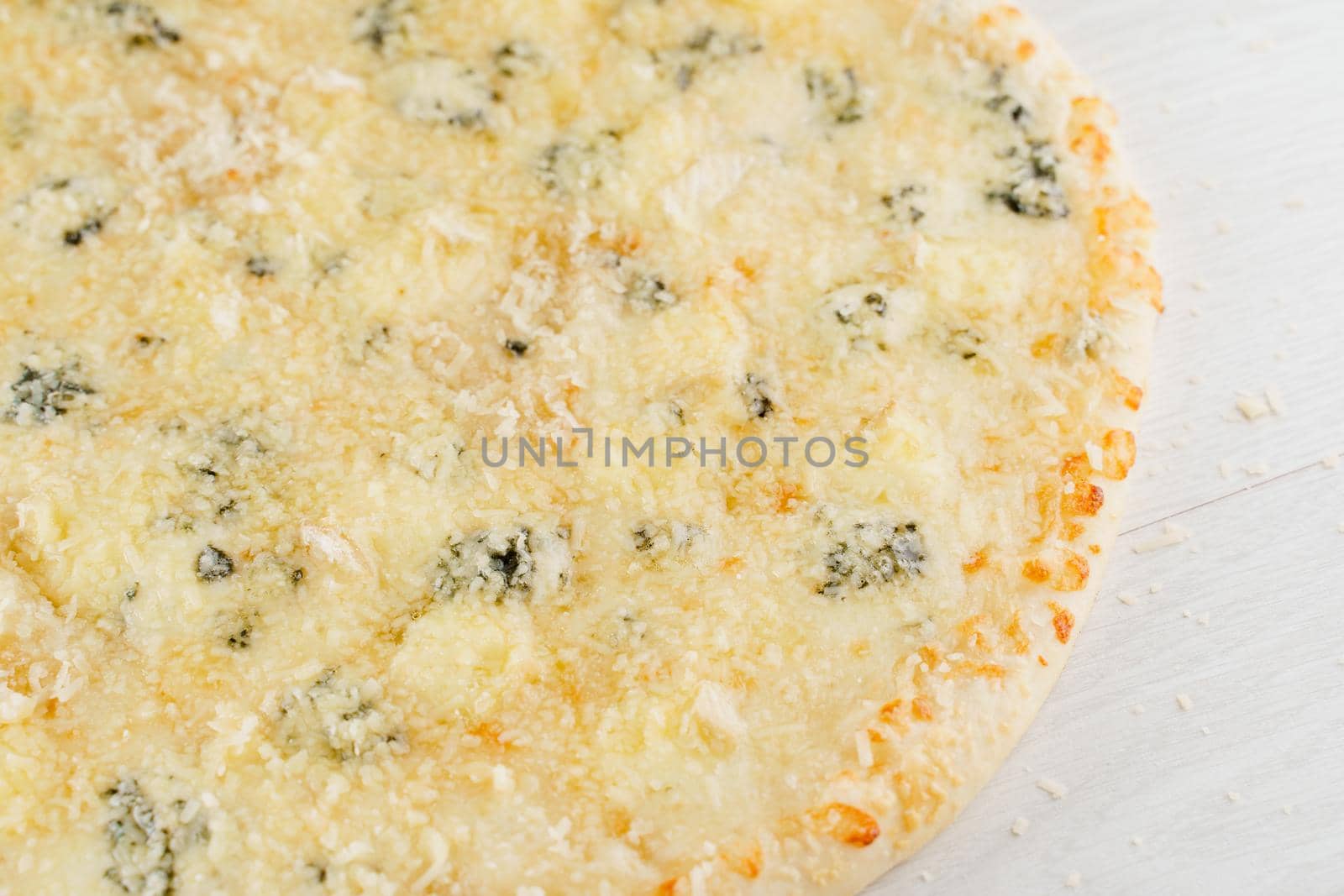 Pizza with cheese such as parmesan, hard cheese, dor blue and mozzarella isolated on white wooden background. Advert for social network of restaurants, caffee