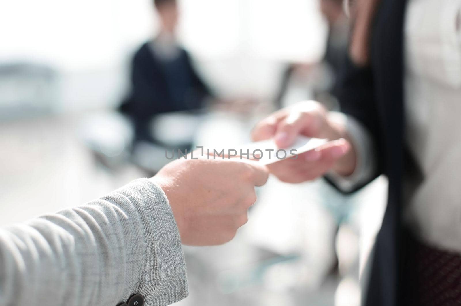 close up.two business woman exchanging business card .photo with text space