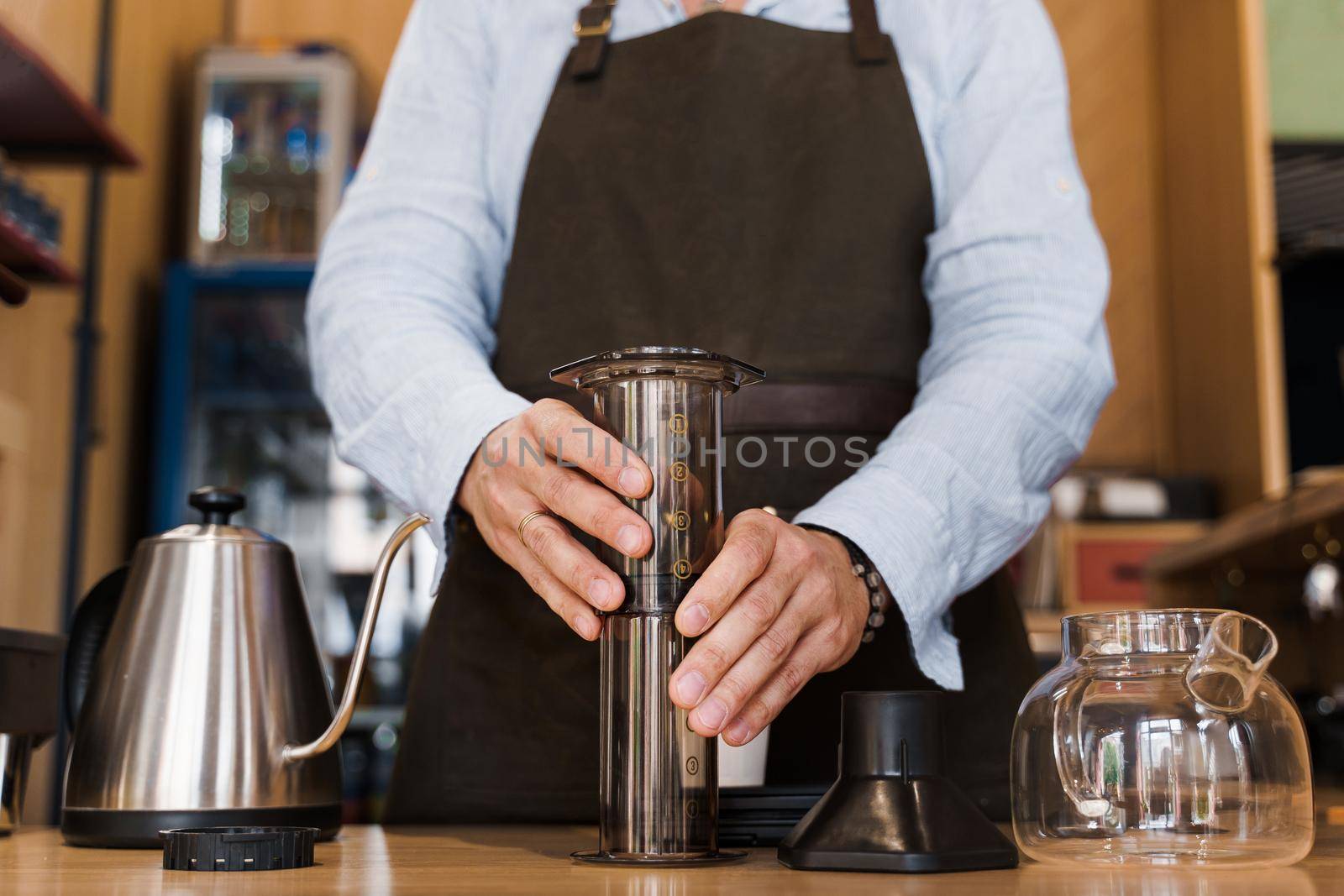 Aeropress coffee alternative making by barista in the cafe. Barista connect details from aeropress together. prepare aeropress to pour it