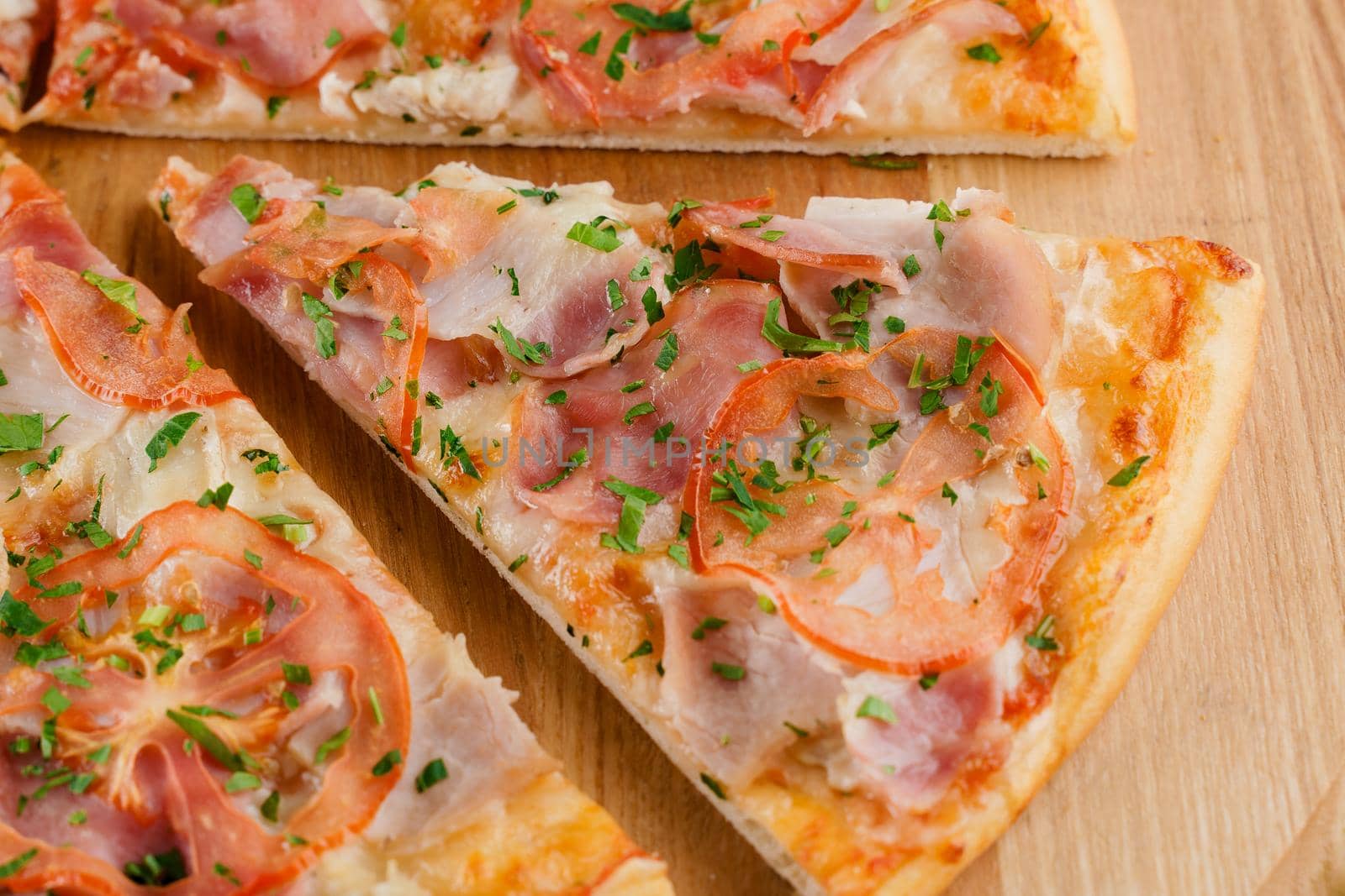 Pizza close-up on white wooden background. Food delivery for people who stay at home. Tasty fast food at quarantine coronavirus covid-19 period.