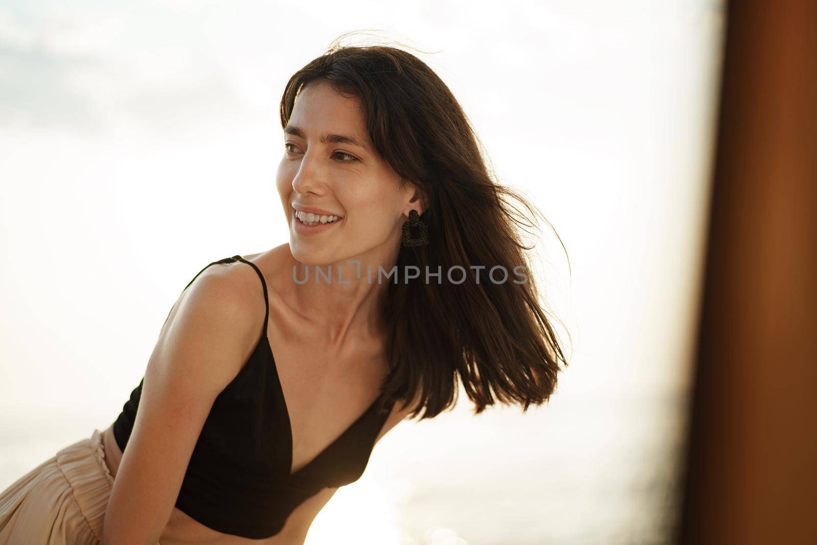 Young smiling woman outdoors portrait at beach by Fabrikasimf