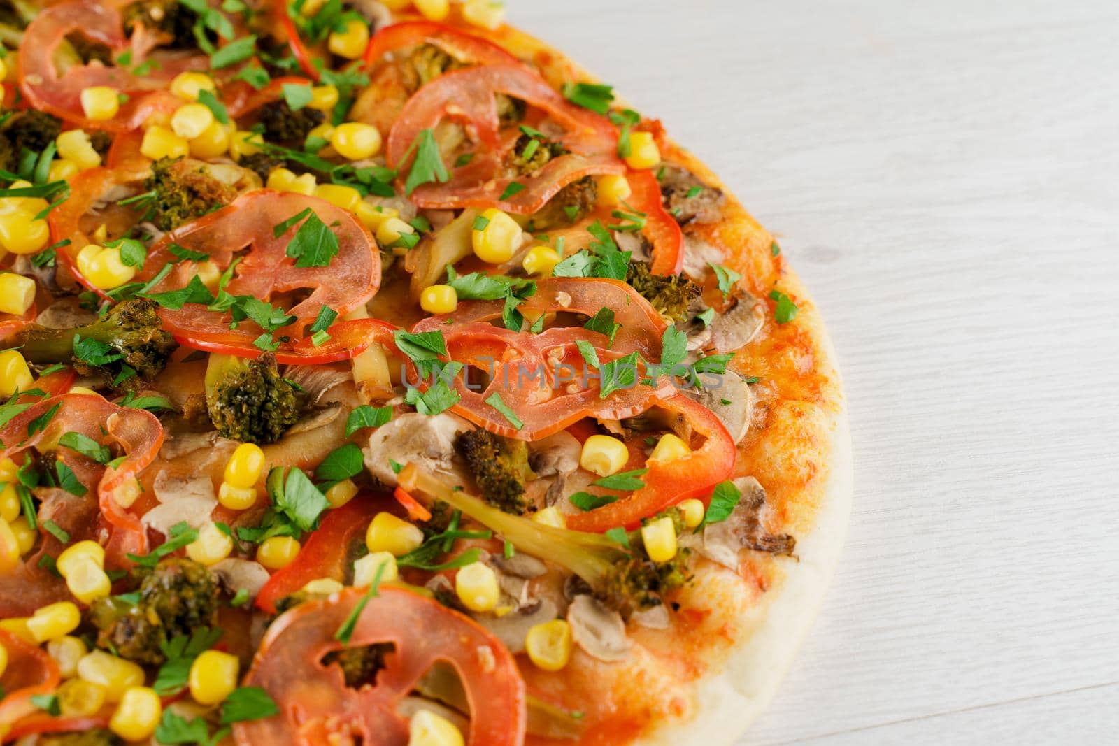 Pizza close-up on white wooden background. Food delivery for people who stay at home. Tasty fast food at quarantine coronavirus covid-19 period.