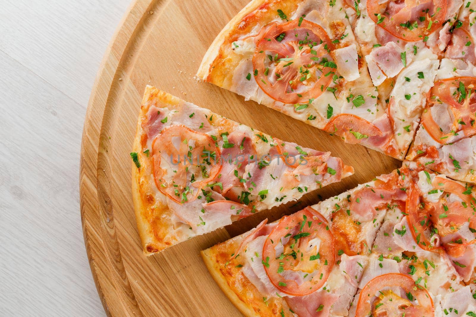 Pizza top view cutted on 8 pieces and one pushed forward. Advert for pizzeria caffee and restaurant. Food delivery at quarantine covid-19 concept.