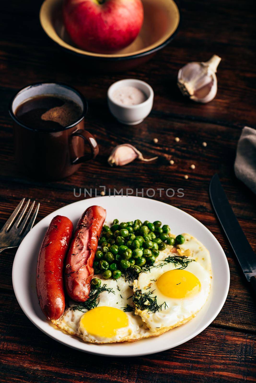 Breakfast with fried eggs, sausages and green peas by Seva_blsv
