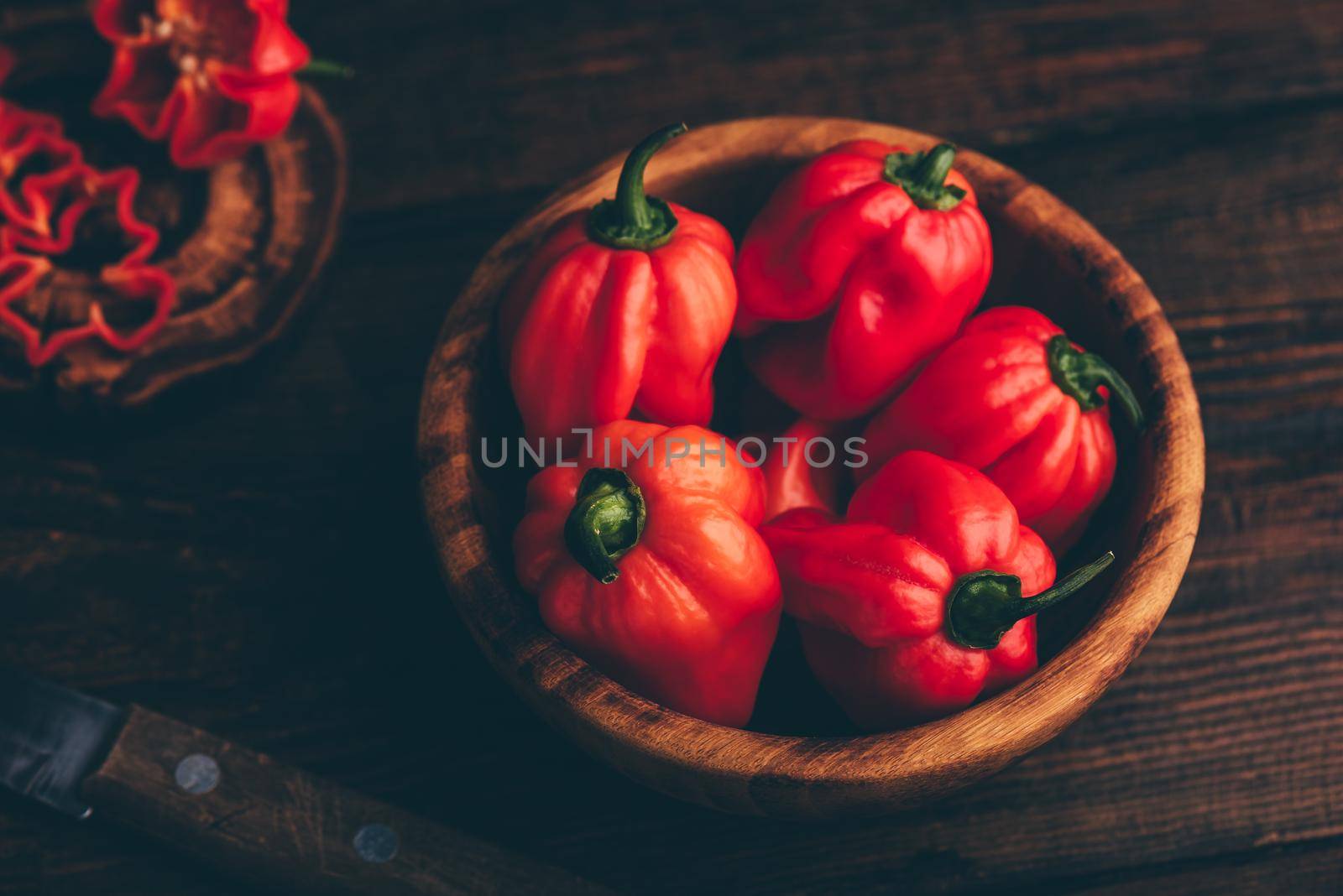 Red Habanero Chili Peppers in a Wooden Bowl by Seva_blsv