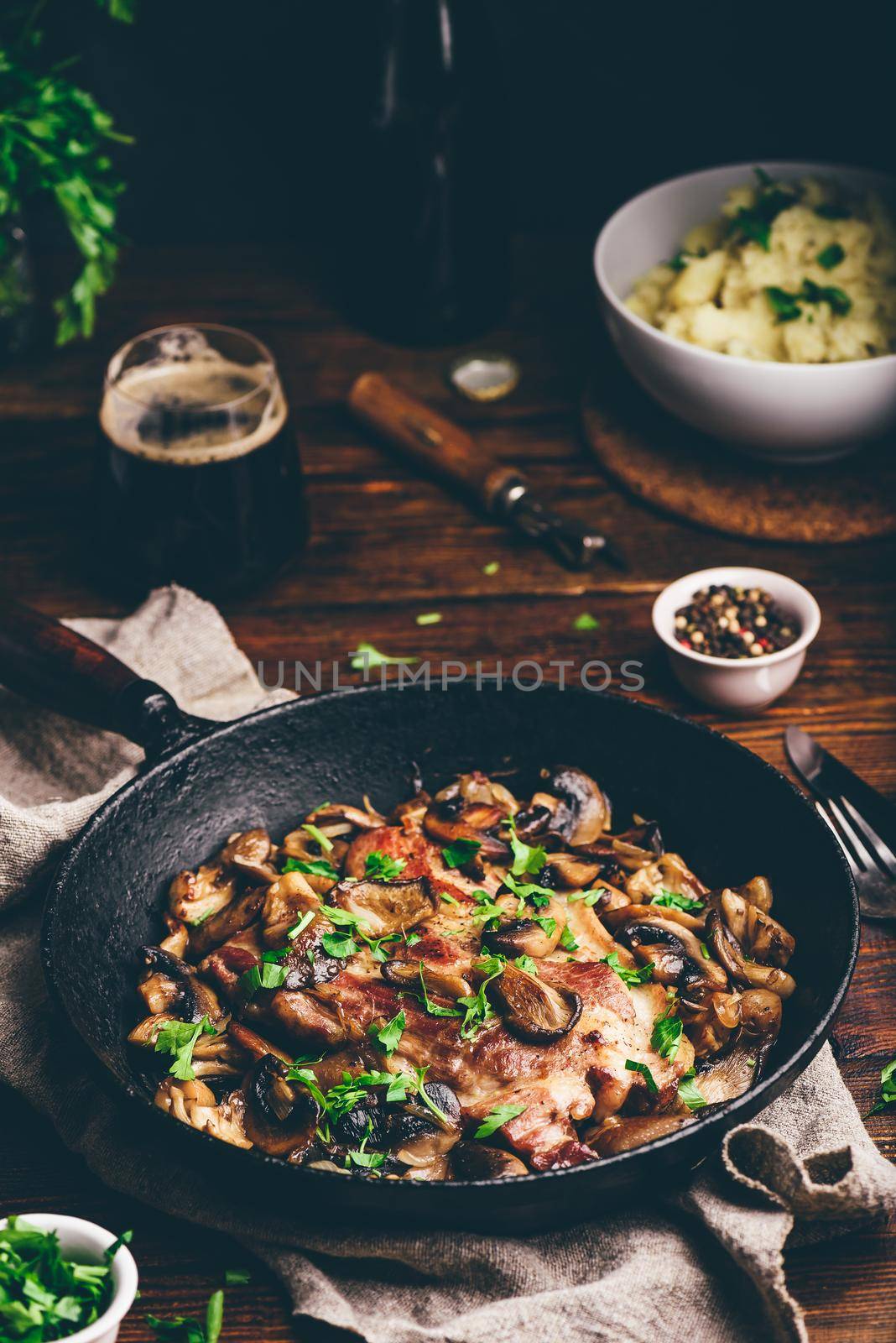 Fried pork neck steak with different mushrooms and mashed potatoes