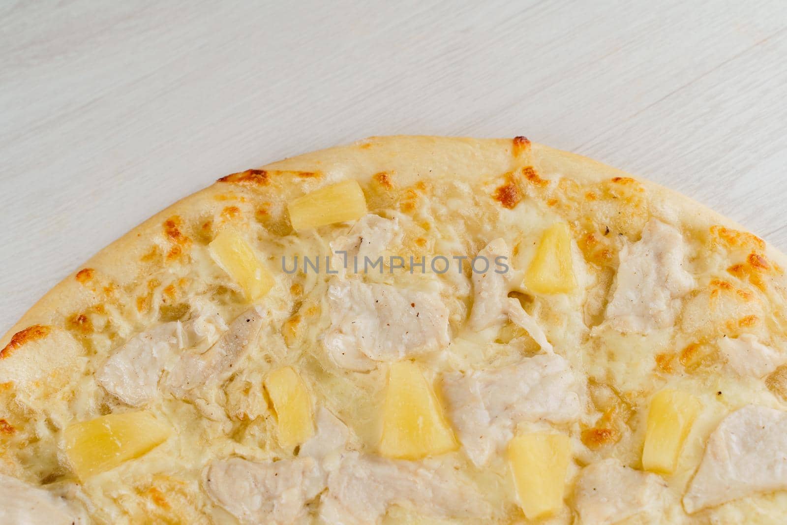 Pizza close-up on white wooden background. Food delivery for people who stay at home. Tasty fast food at quarantine coronavirus covid-19 period.