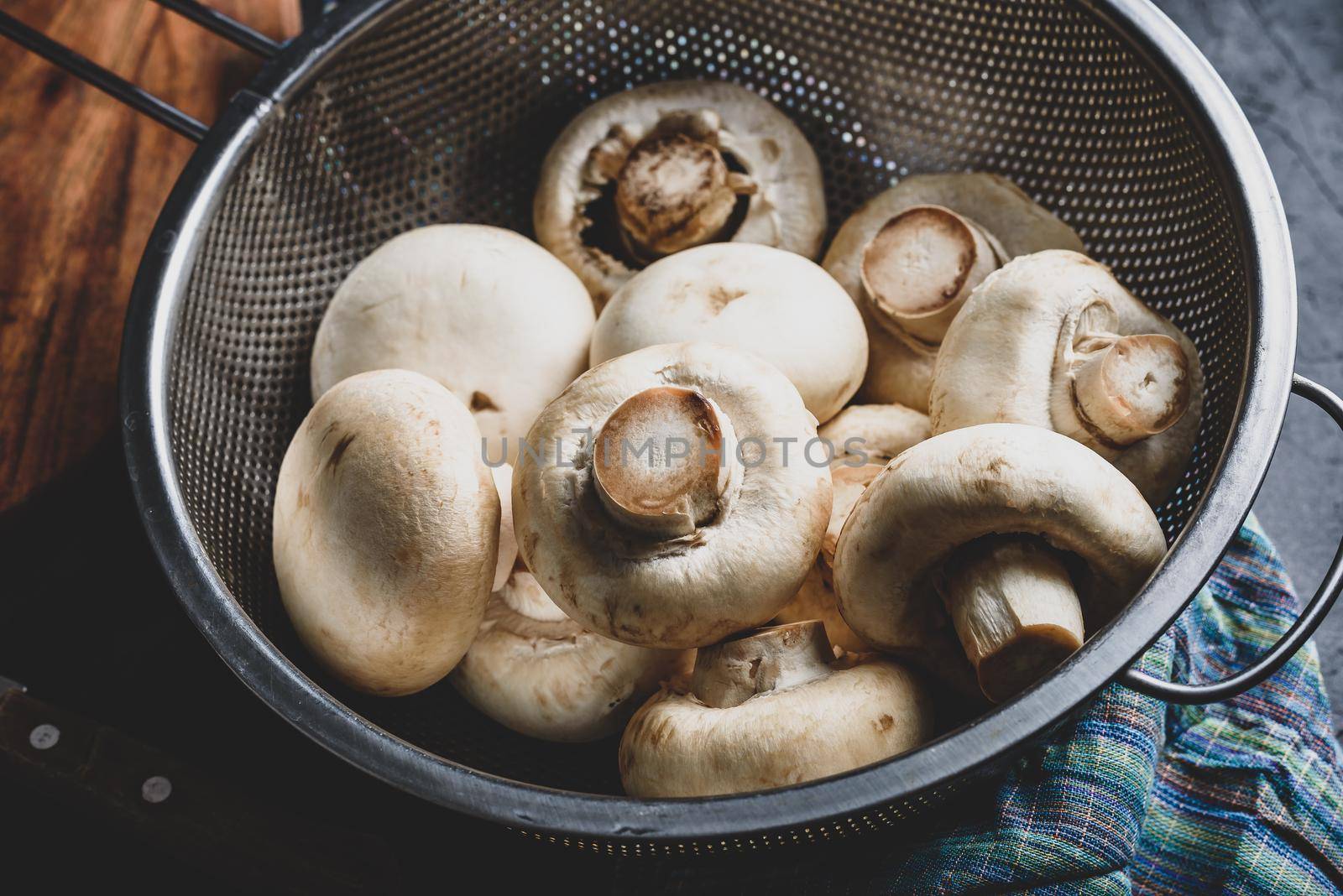 Button mushrooms in metal colander by Seva_blsv