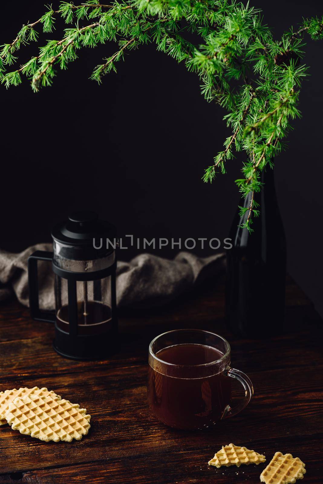 Cup of coffee brewed in french press with waffles on rustic wooden table
