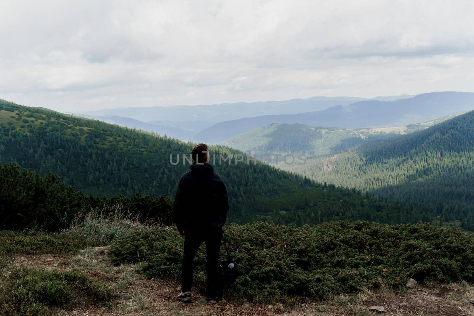 Hiking and climbing up to the top of the mountain. Men tourist is travelling and standing at the root of the mountain and watching to the peak.