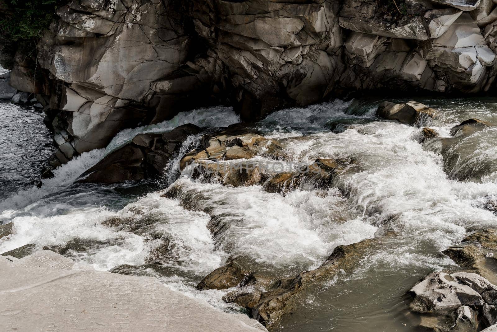 Waterfall in the mountain river with big rocks. Travelling in quarantine period. Nature landscape. Karpathians mountains.