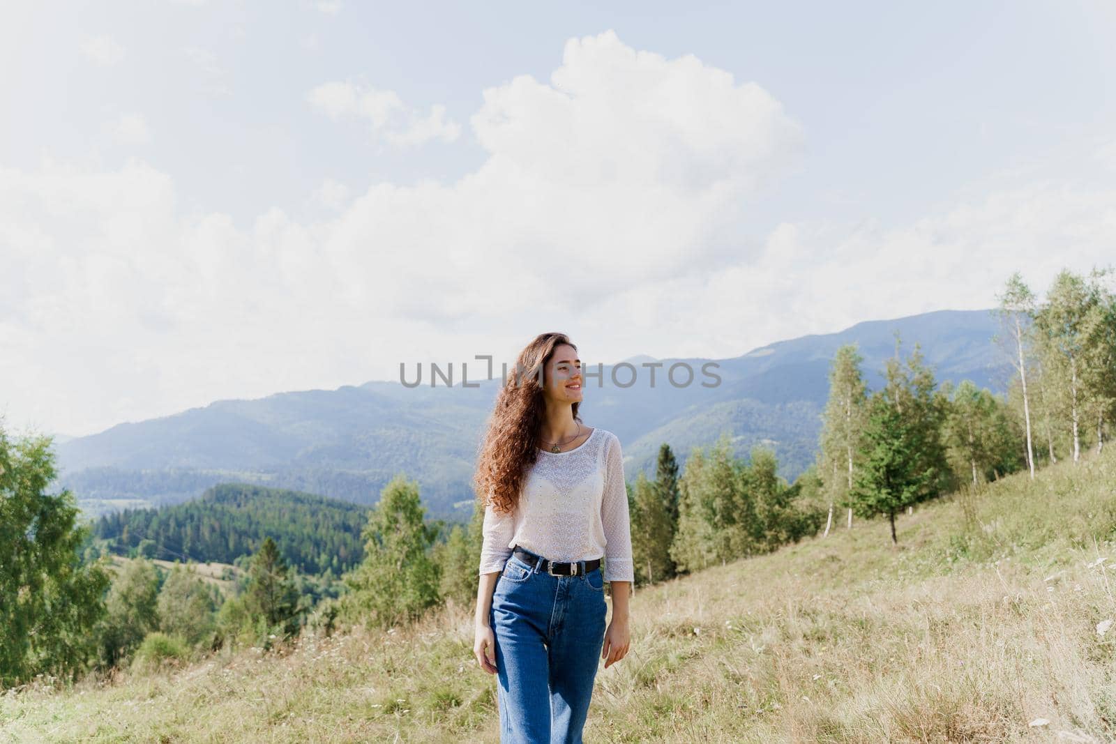 Girl enjoying the mountain hills view. Feeling freedom in Karpathian mountains. Tourism travelling in Ukraine by Rabizo