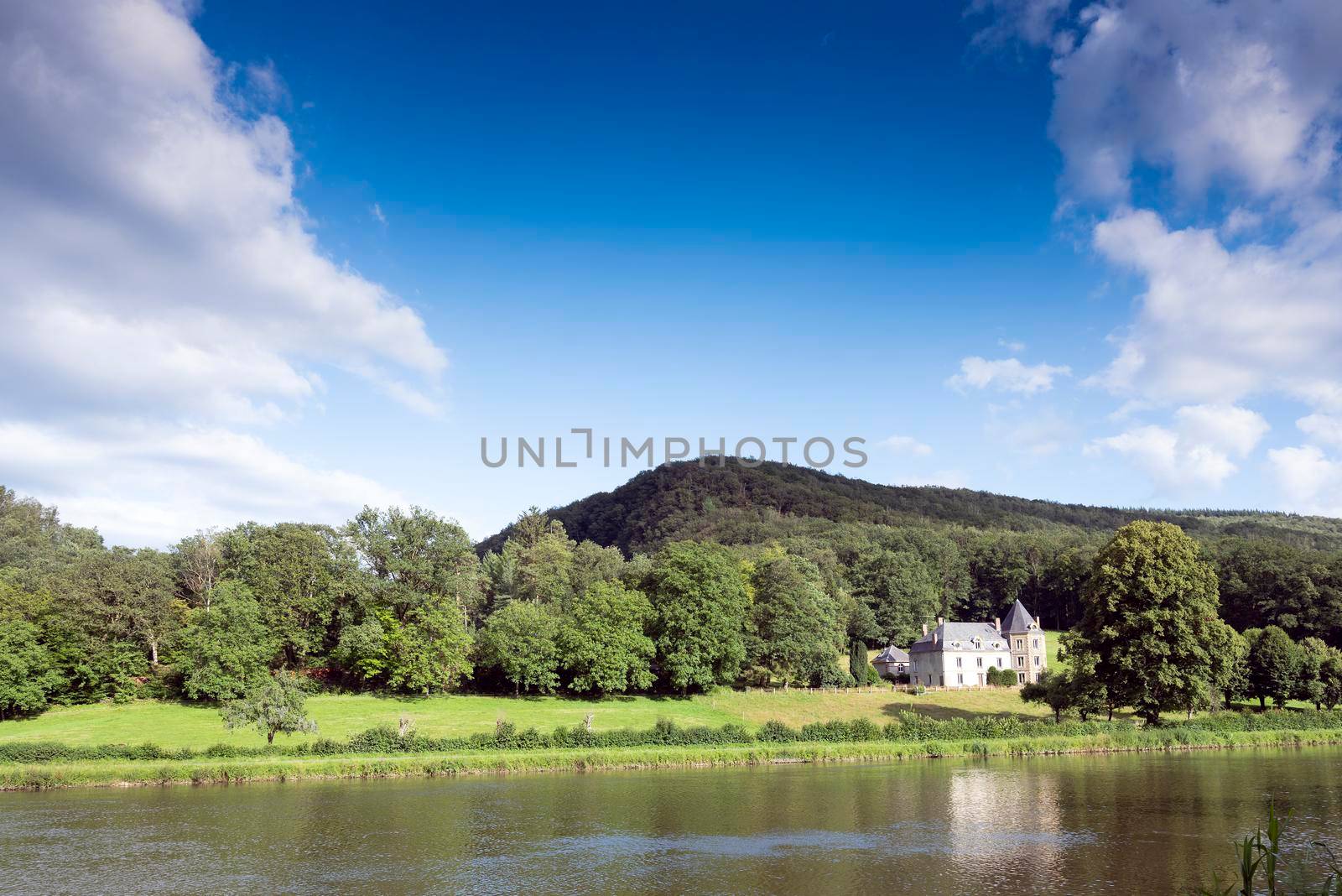 large mansion and forest near river maas in countryside of french ardennes in tyhe north of france