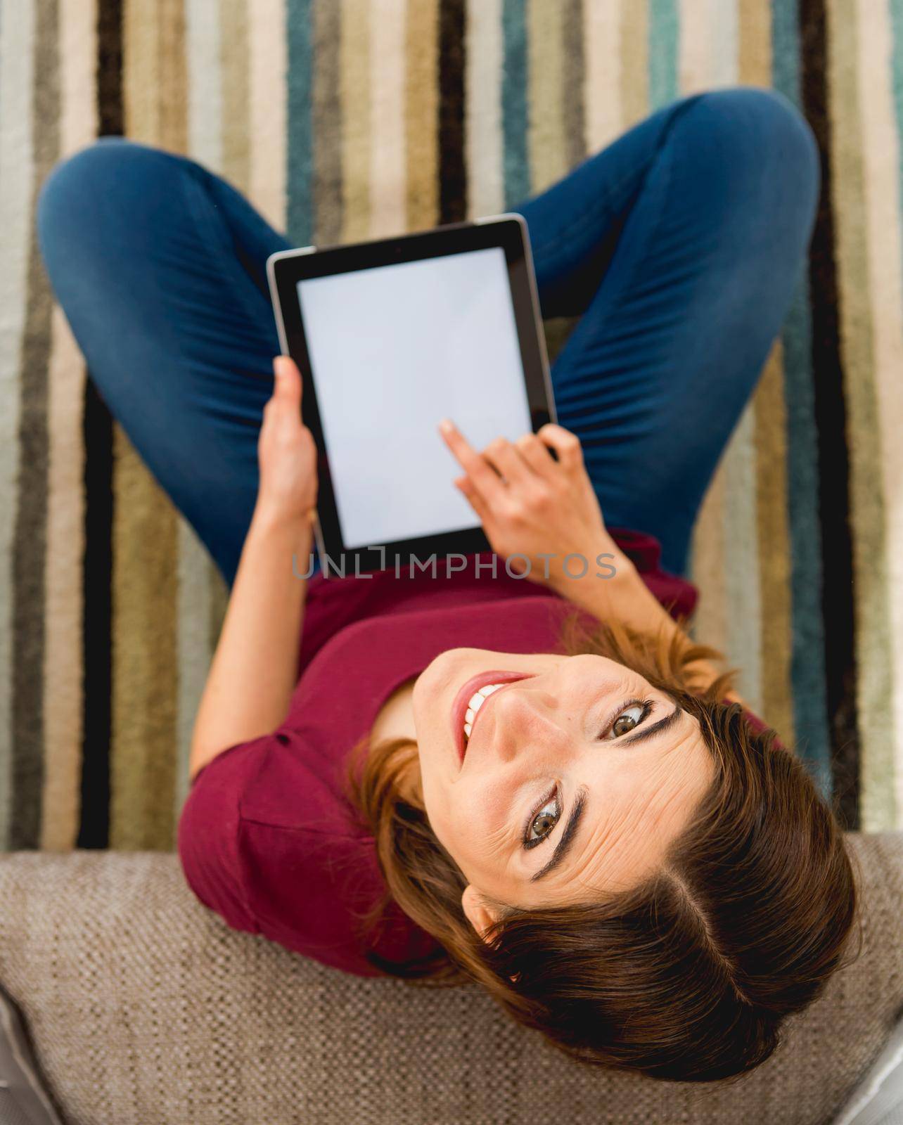 Woman using a digital tablet by Iko