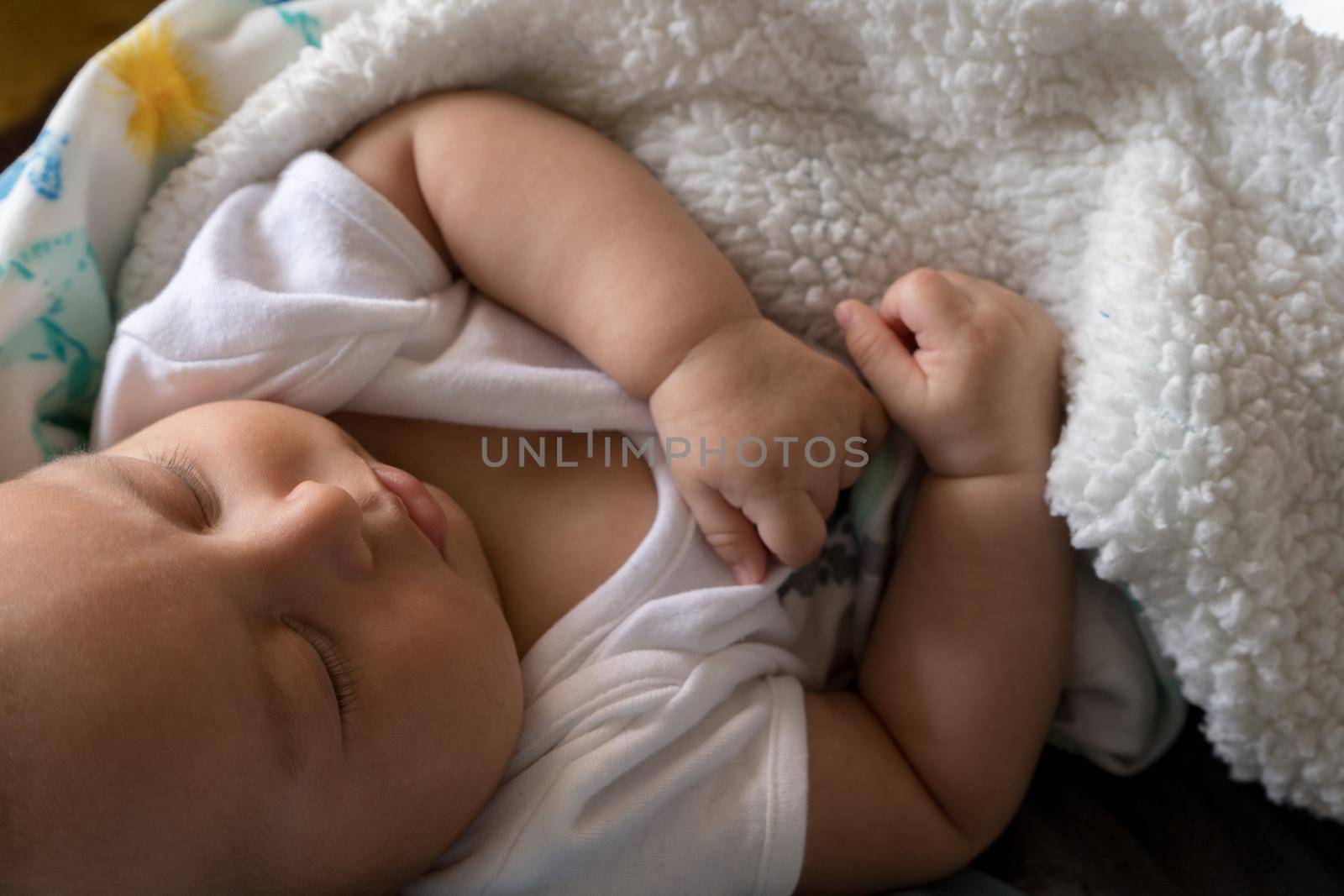 Latin Baby and tired is sleeping in daddy arms. lifestyle high quality photo horizontal cenital view