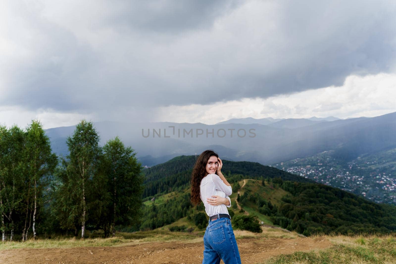 Tourism travelling in Ukraine. Girl enjoying the mountain hills view before rain. Feeling freedom in Karpathian mountains by Rabizo