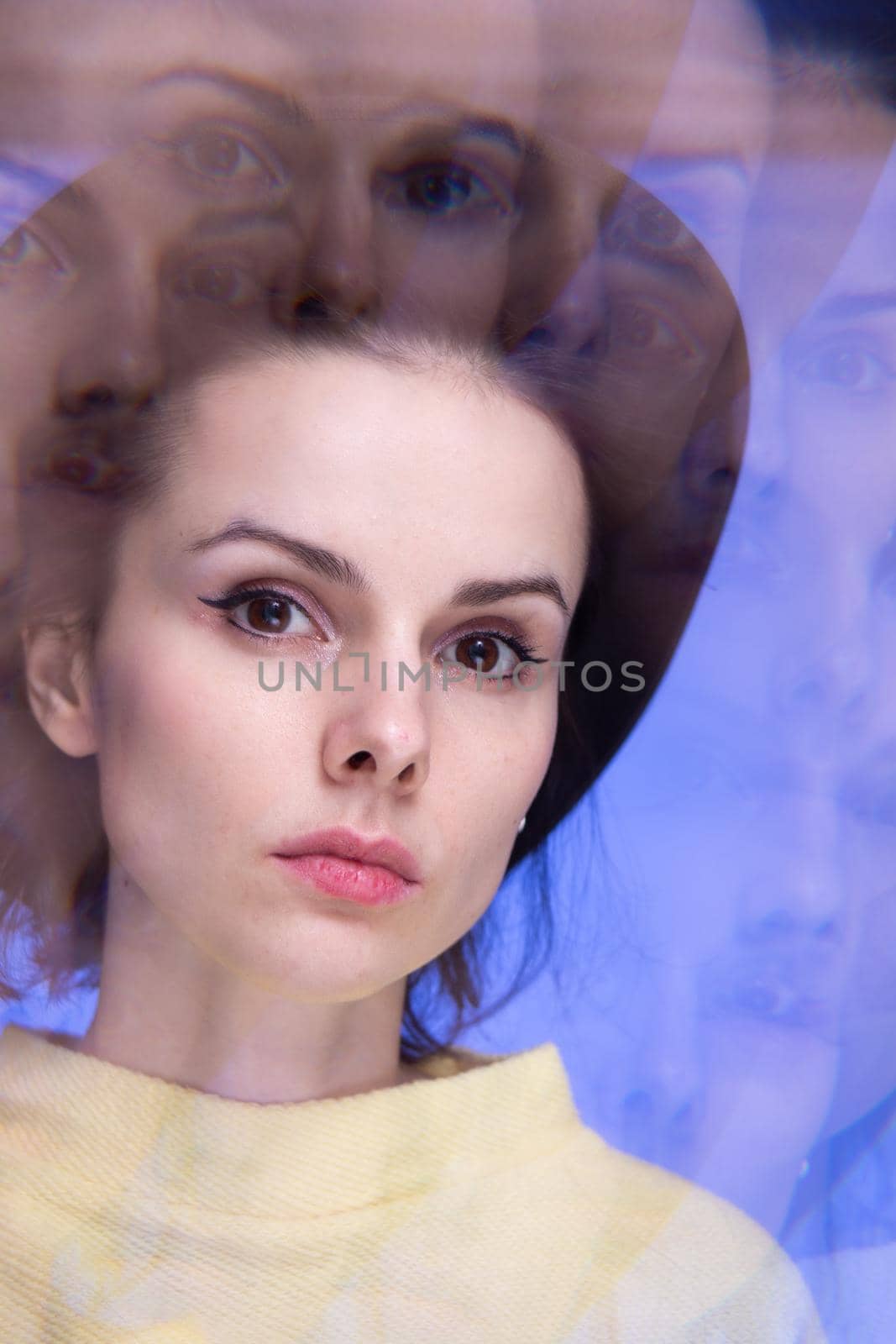 beautiful woman in a yellow sweater, art portrait of a caledoscope. High quality photo