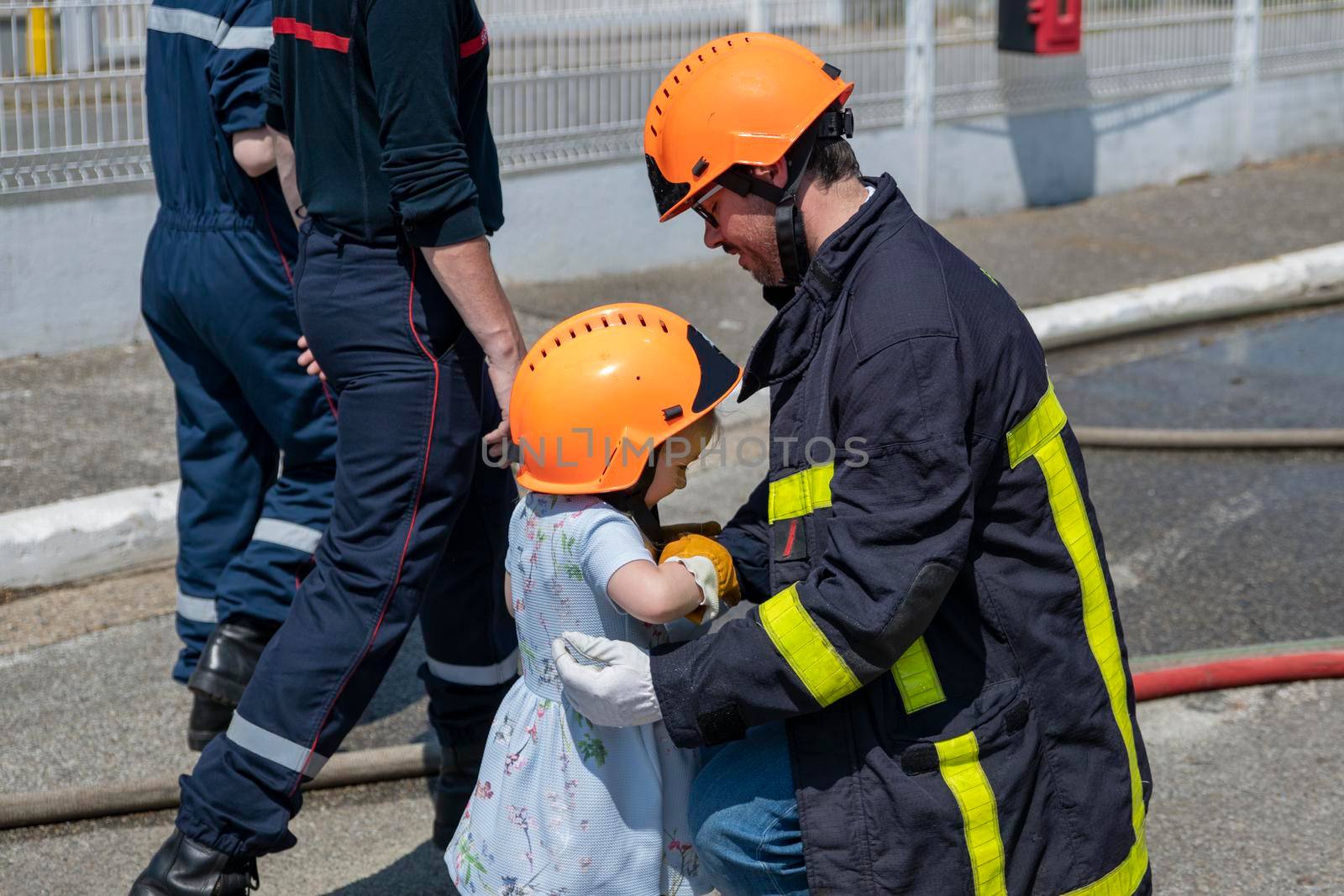 Fire uniformed father teaches his daughter Firefighter