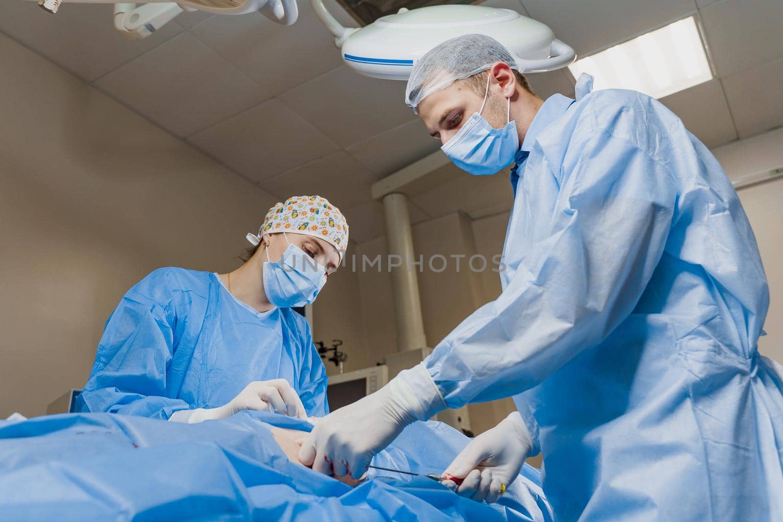 Liposuction for lipofilling surgery operation. 2 surgeon do plastic surgery named blepharoplasty in medical clinic.