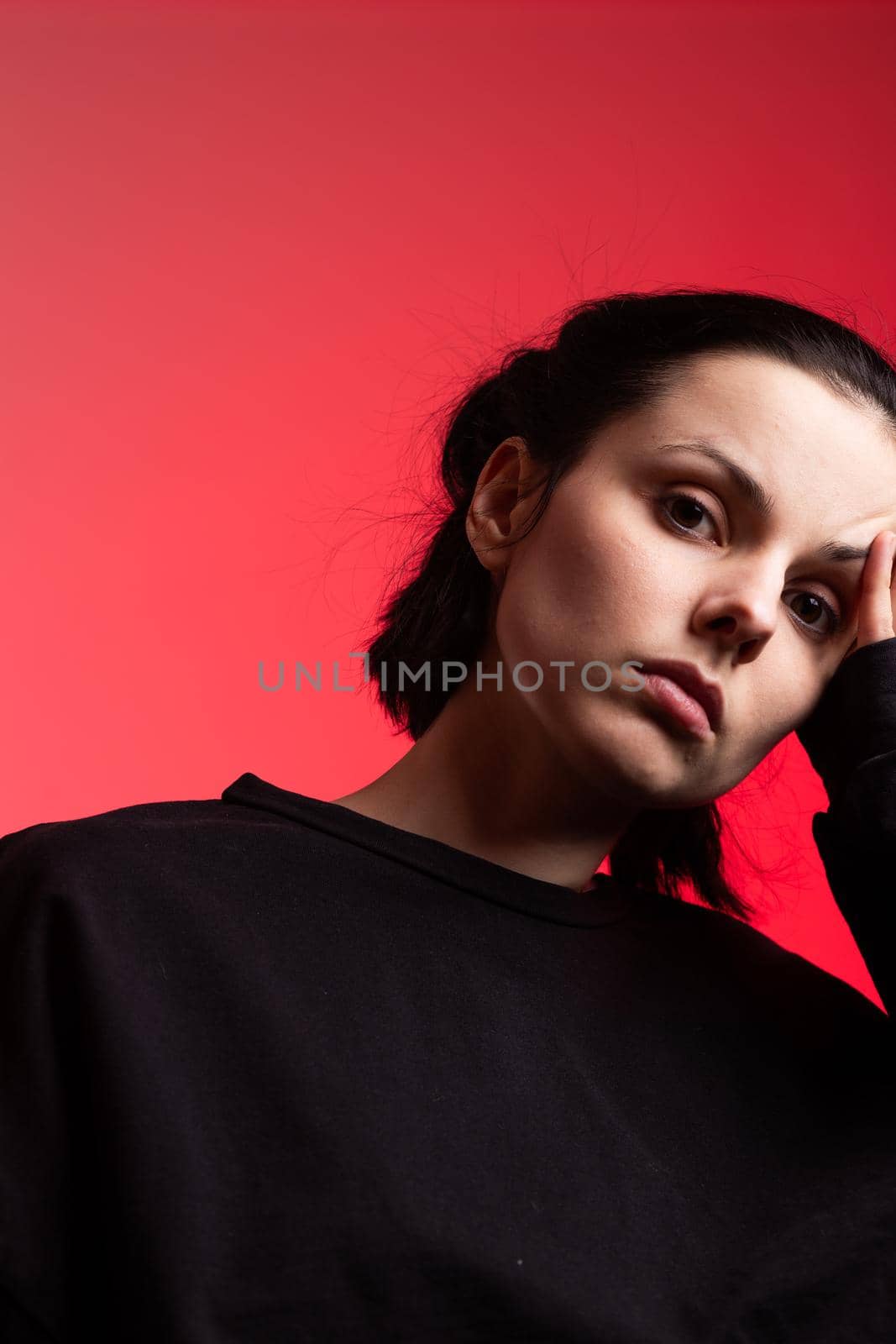 brunette woman in black clothes on red background by shilovskaya