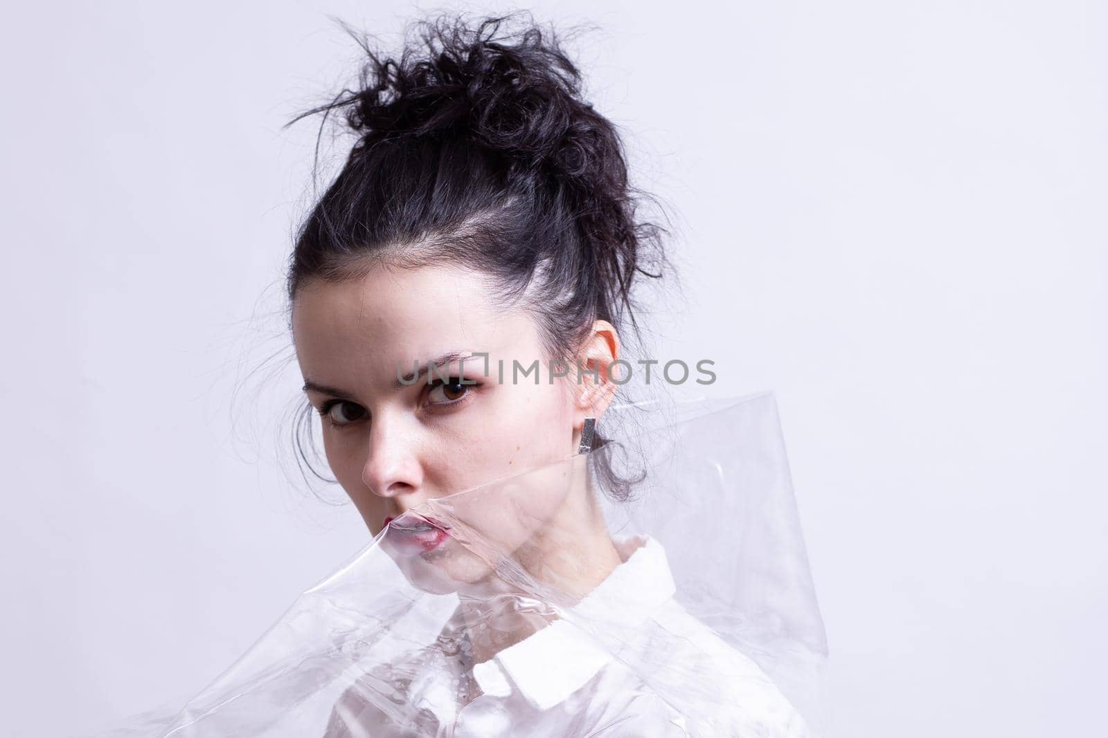 woman with red lips wrapped in plastic wrap. High quality photo