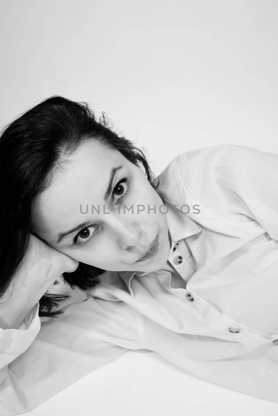 brunette woman lies on the floor, black and white photo by shilovskaya