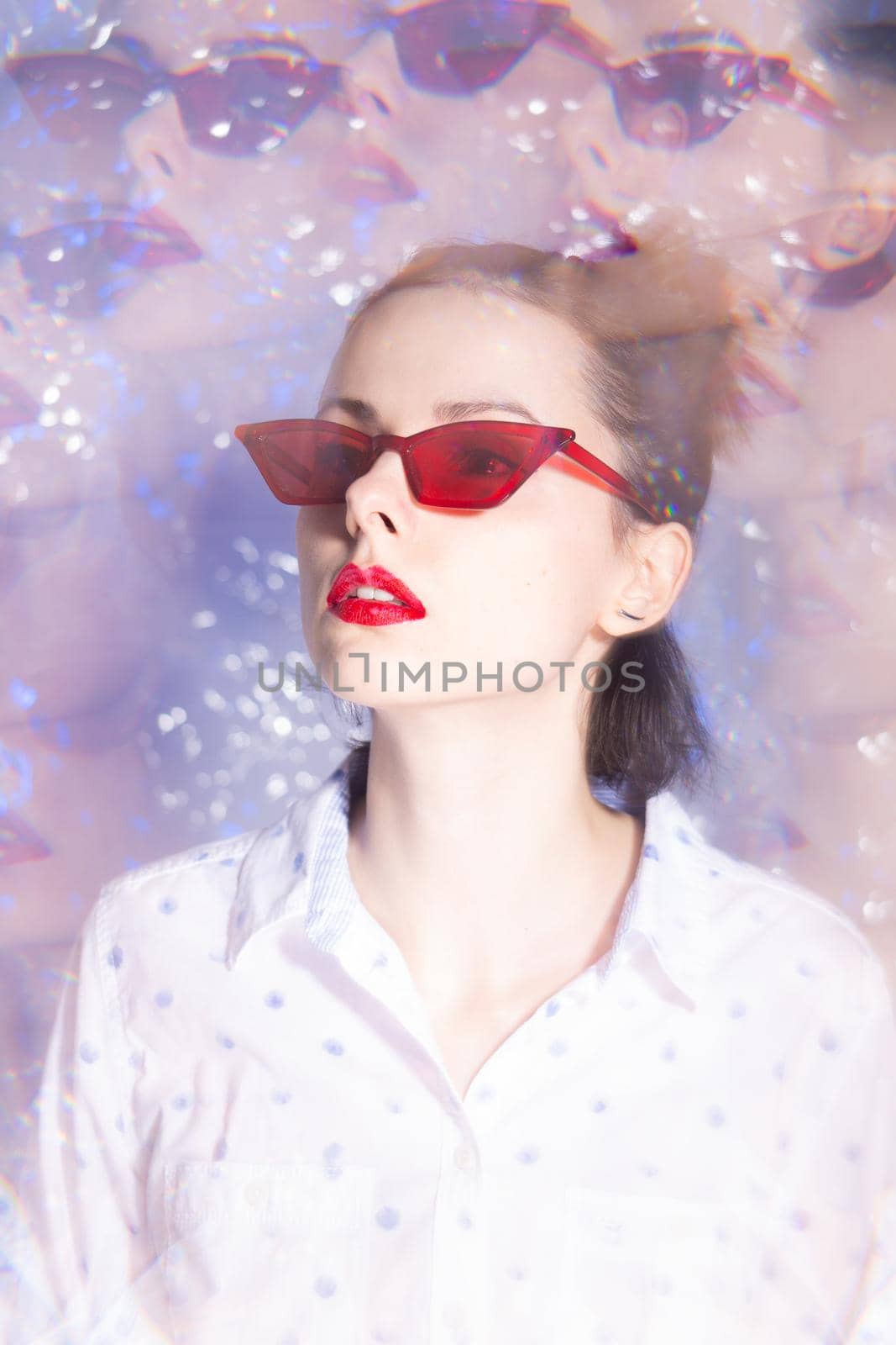 art portrait of a woman in green glasses with red lipstick on her lips in a white shirt by shilovskaya
