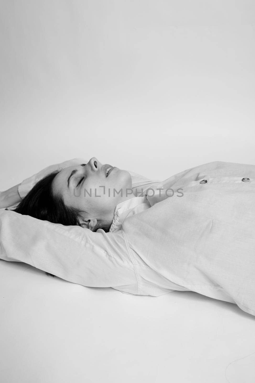 brunette woman lies on the floor, black and white photo. High quality photo
