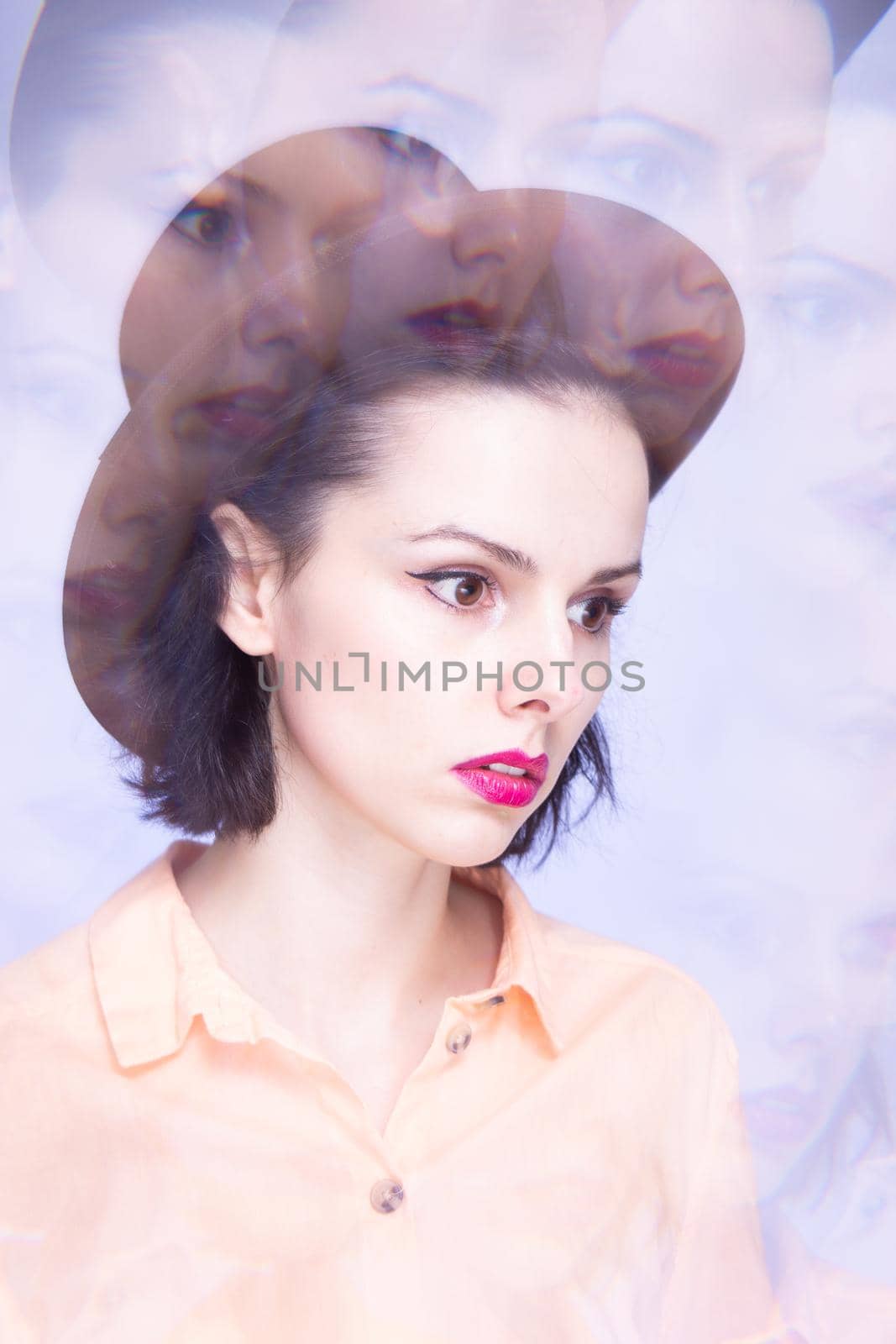 woman with pink lips in a hat on a blue background, art portrait by shilovskaya