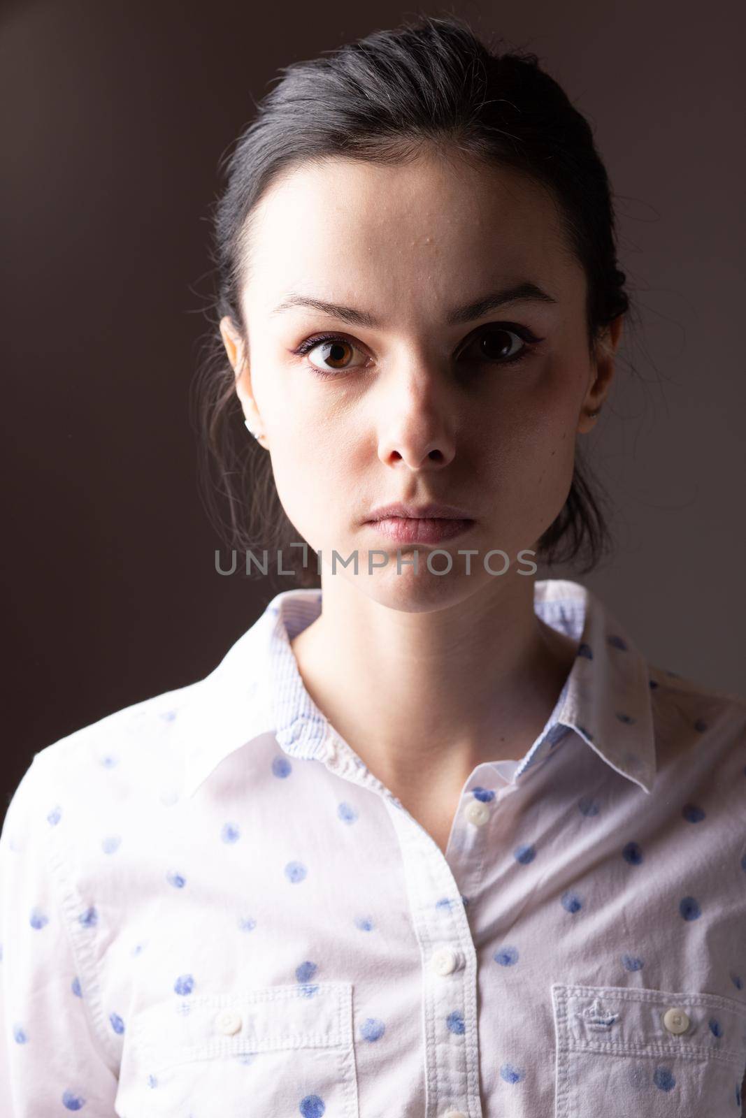 brunette woman in white polka dot shirt. High quality photo