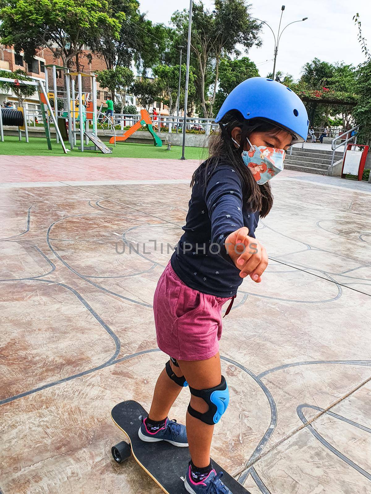 Beautiful skater girl riding on her longboard in the city. by Peruphotoart