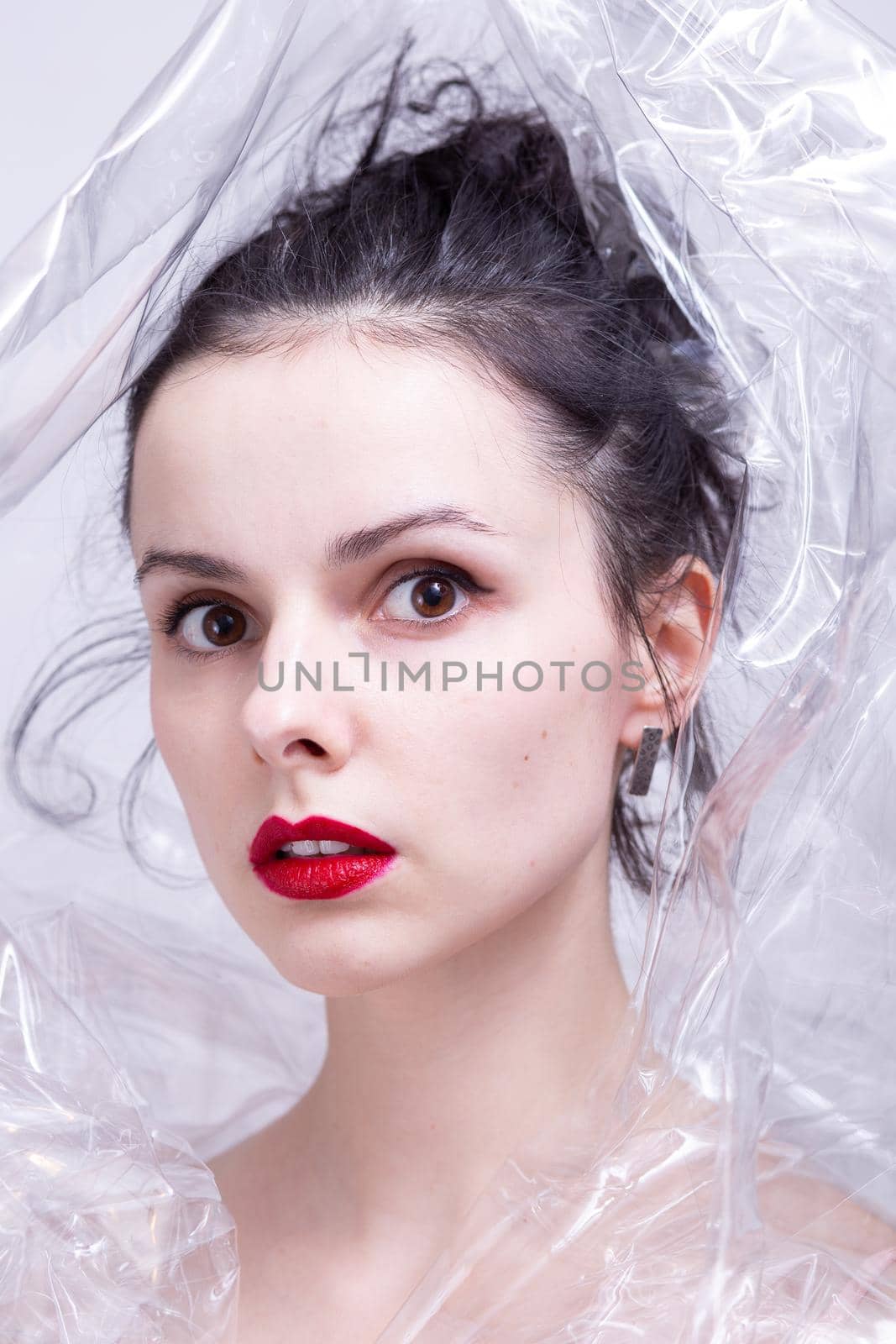 woman with red lips wrapped in plastic wrap. High quality photo