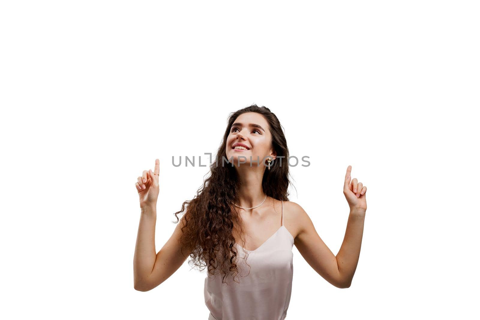 Girl points up and gives 2 variants to choose. Attractive young woman is pointing up and smiles isolated on white background. by Rabizo