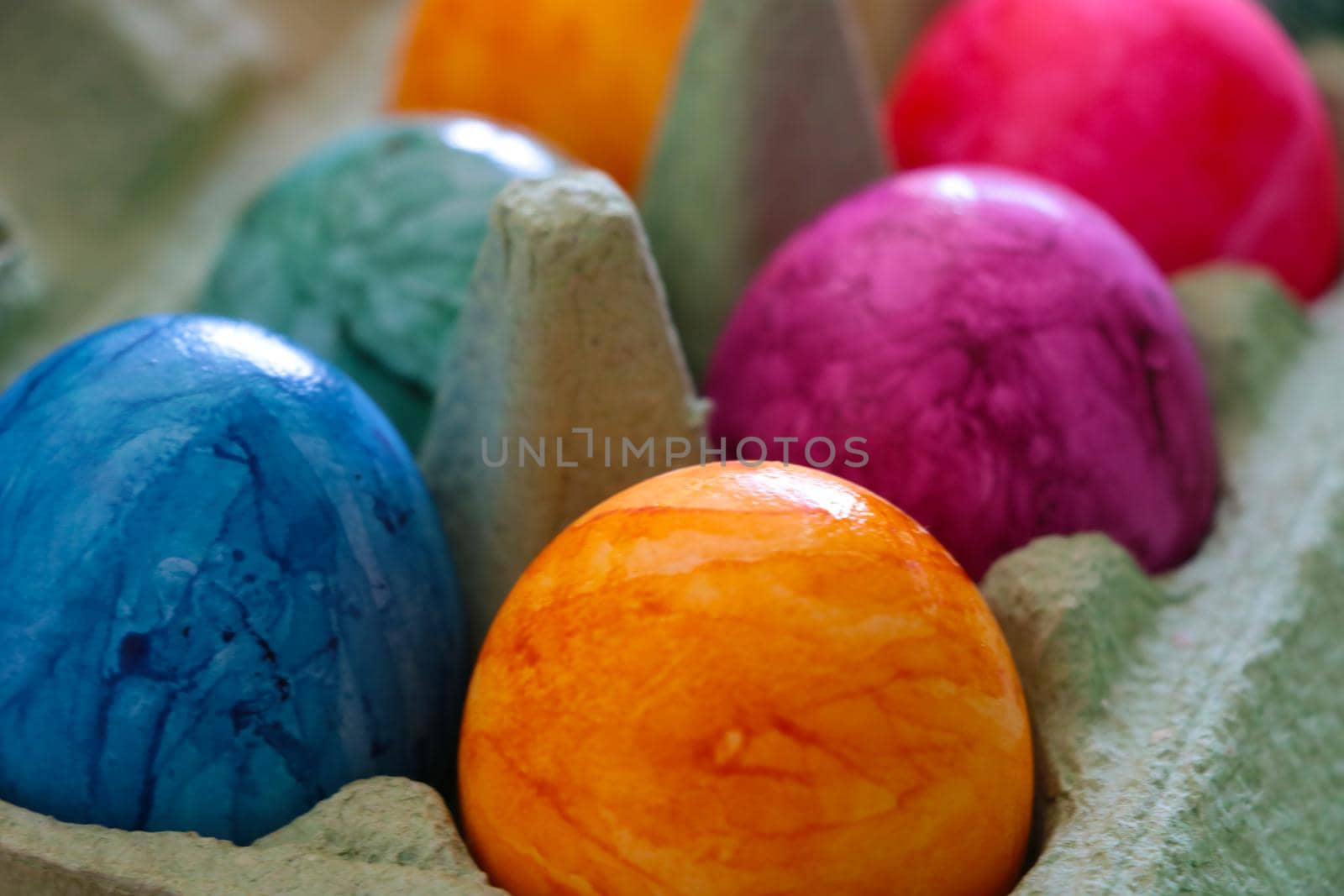 Blurred background. Out of focus. Multi-colored eggs in a package. Out of focus, blurred.