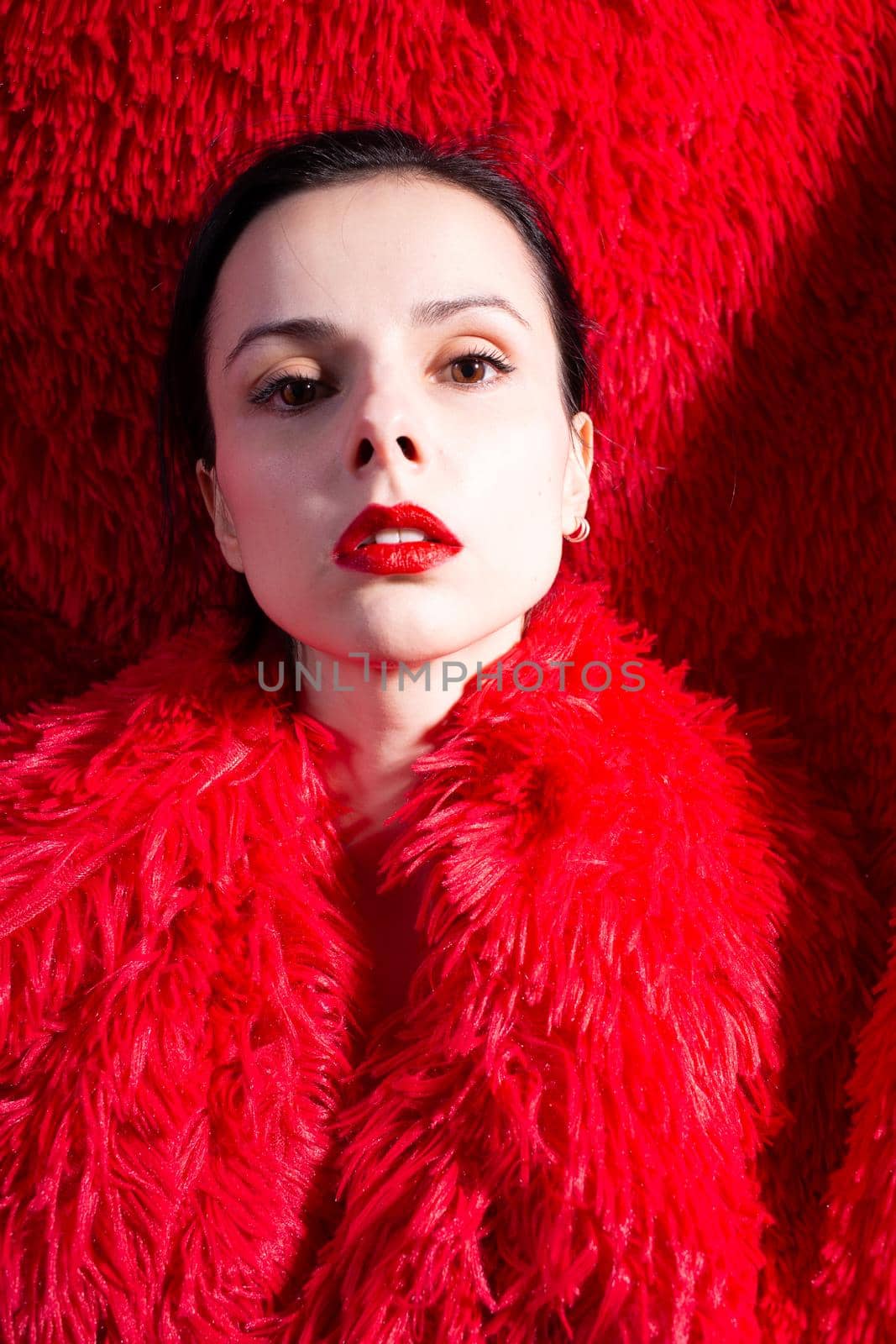 woman with red lips in red fluffy clothes, red fluffy background by shilovskaya