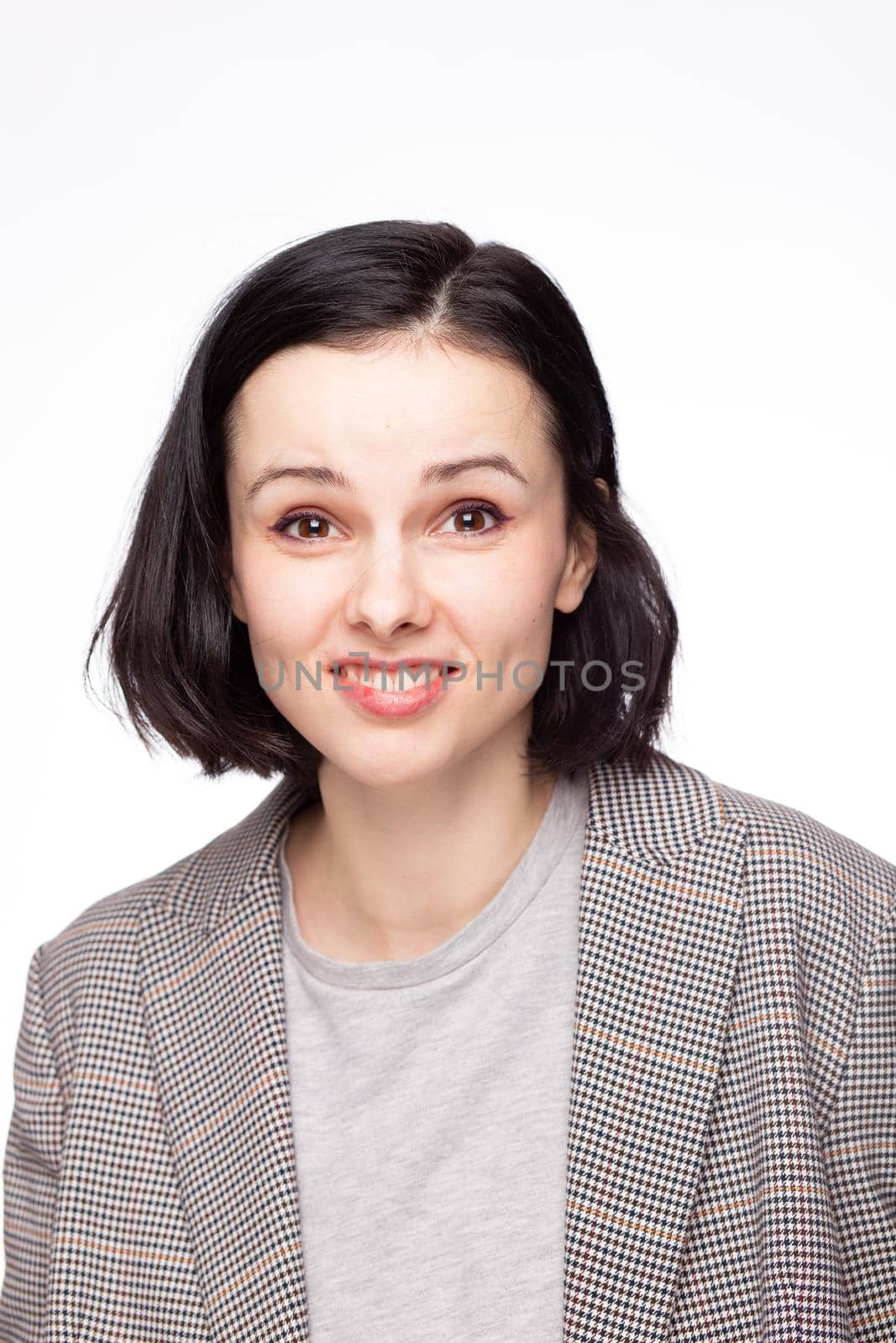 emotional woman in a gray t-shirt and jacket, white background. High quality photo