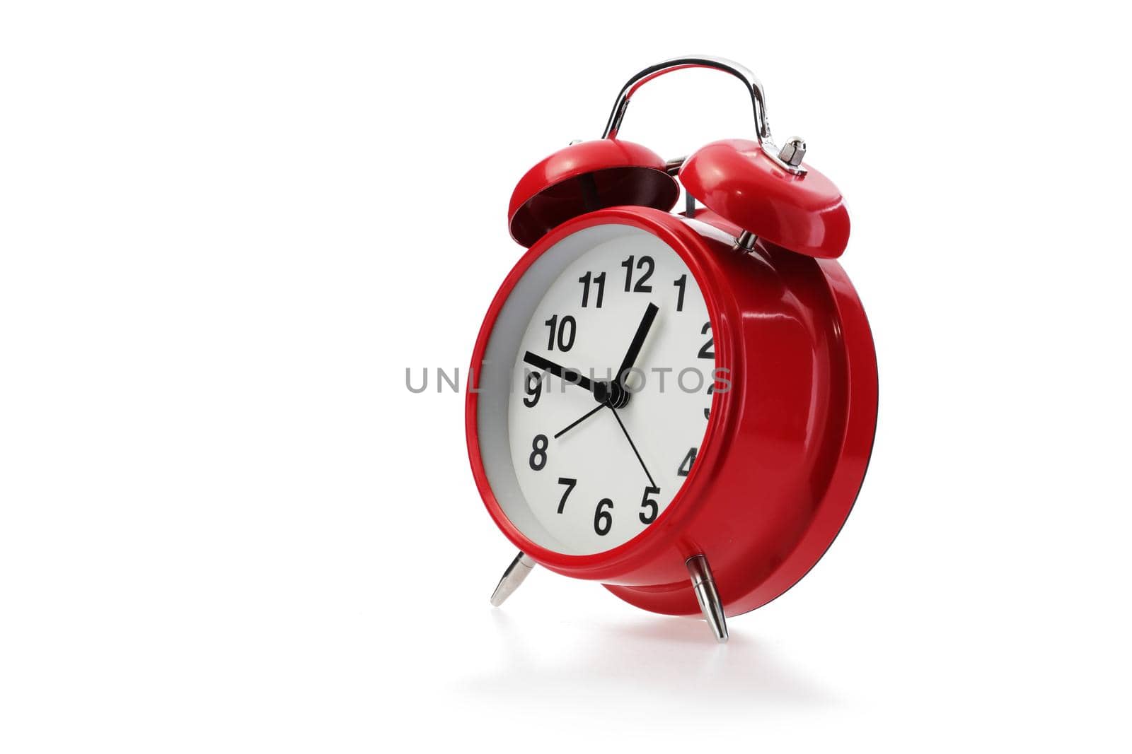 A red retro alarm clock in white with shadow
