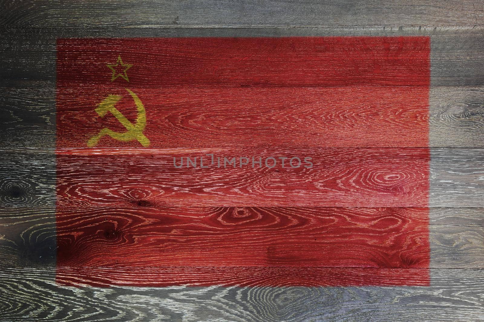 A USSR flag on rustic old wood surface red yellow hammer sickle CCCP