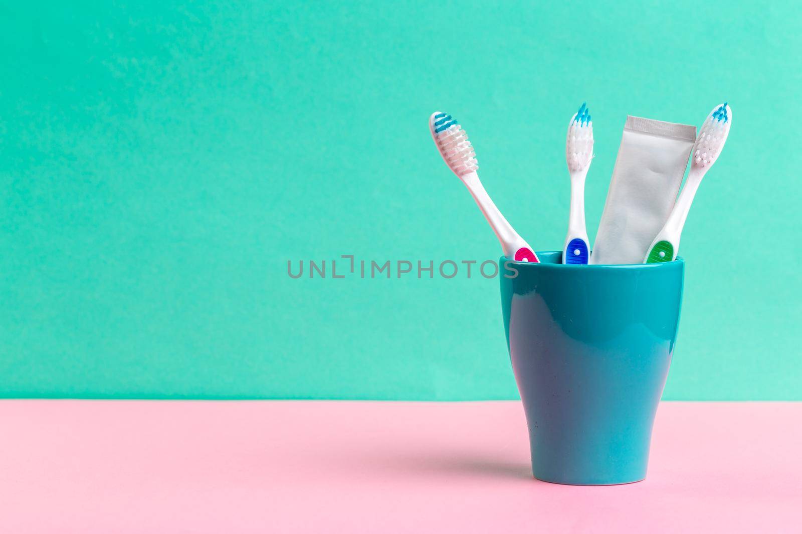 Toothbrushes in glass on the table. creative photo. by Fabrikasimf