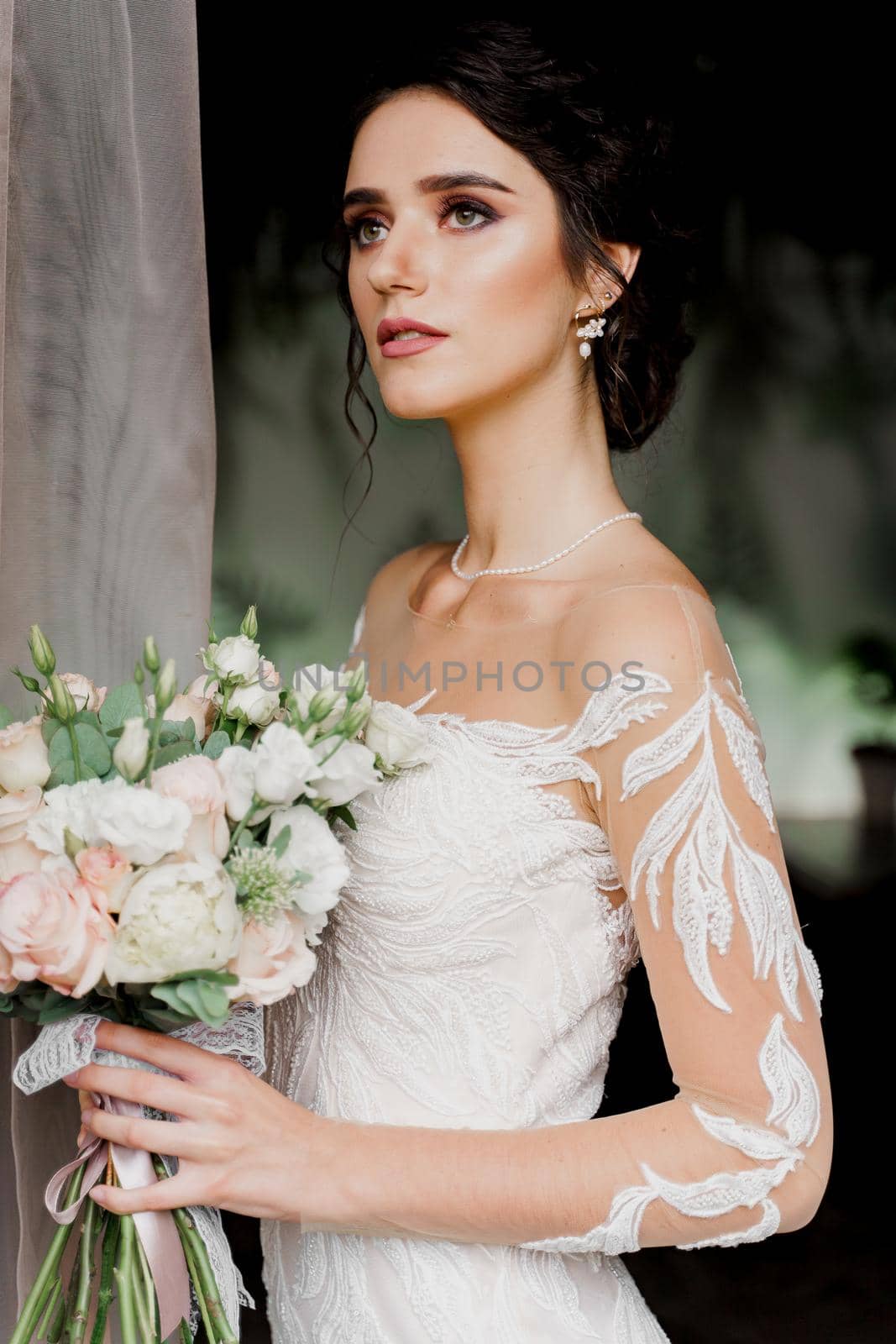 Close-up bride in wedding dress and bridal veil in cafe. Advert for social networks for wedding agency and bridal salon