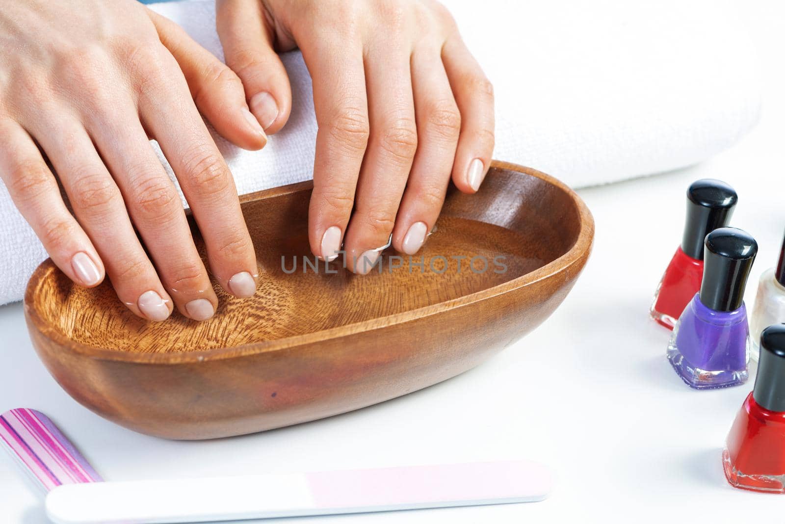 Closeup female hands in wooden bowl with water by adam121