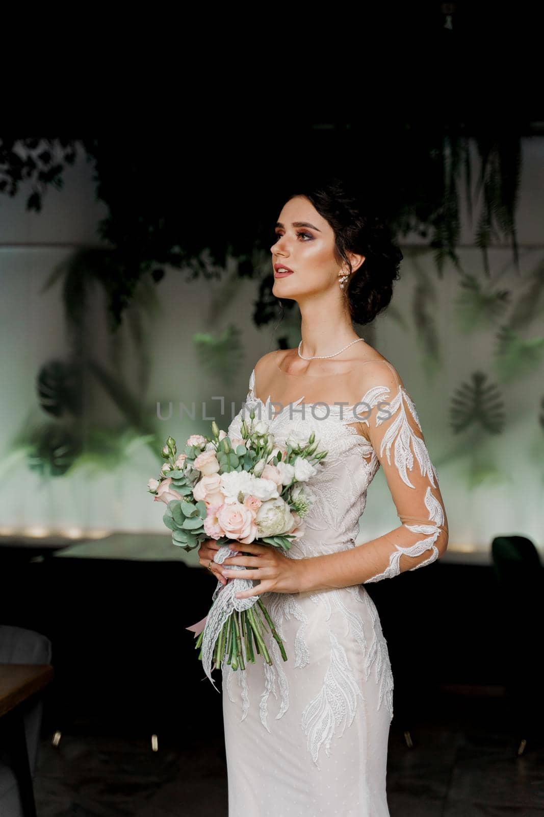 Bride in wedding dress and bridal veil in cafe. Advert for social networks for wedding agency and bridal salon. by Rabizo