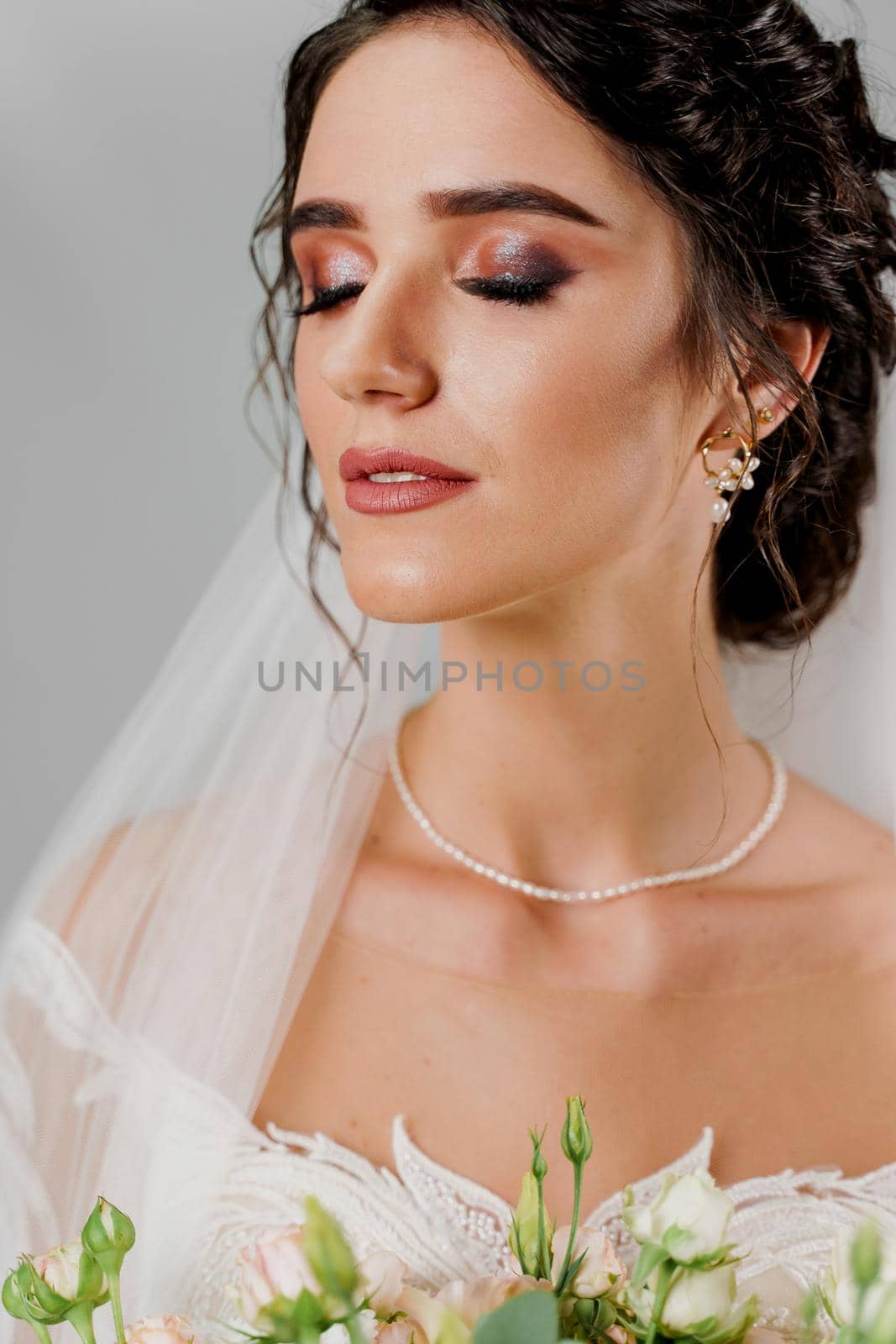 Close-up bride portrait with closed eyes in studio. Advert for social networks for wedding agency and bridal salon