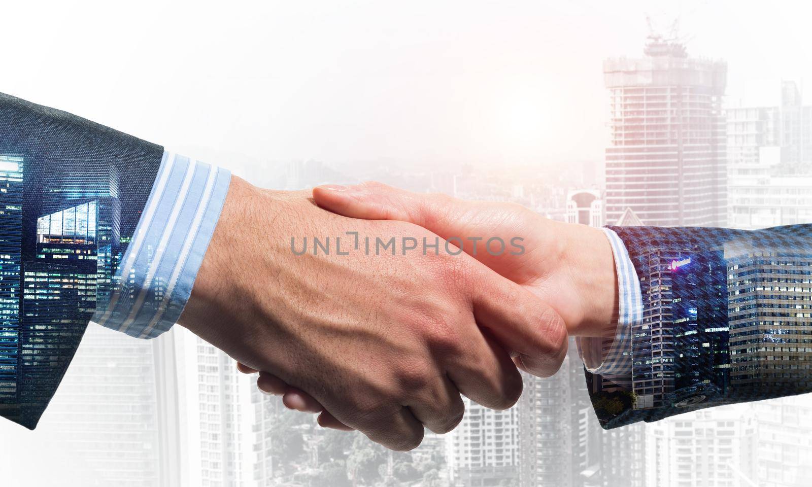 Close-up of the handshake of businessmen. Against the backdrop of the cityscape