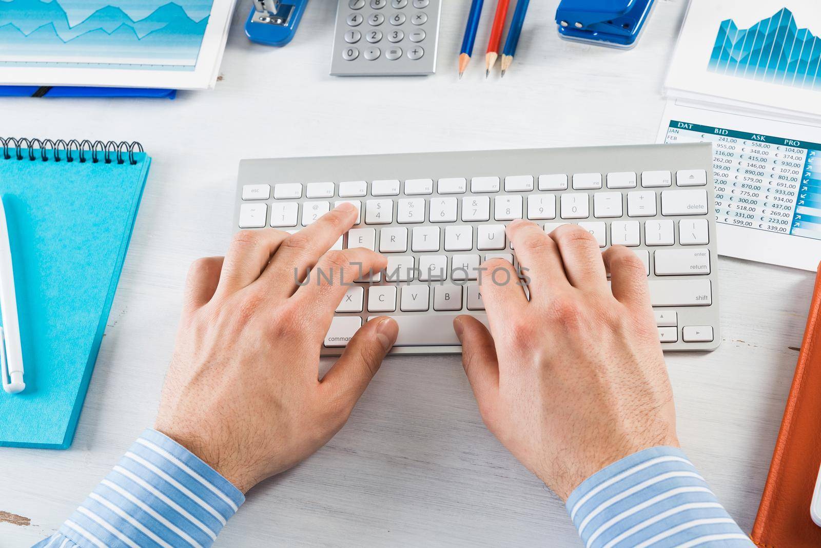 close-up men's hands type on the keyboard. office work