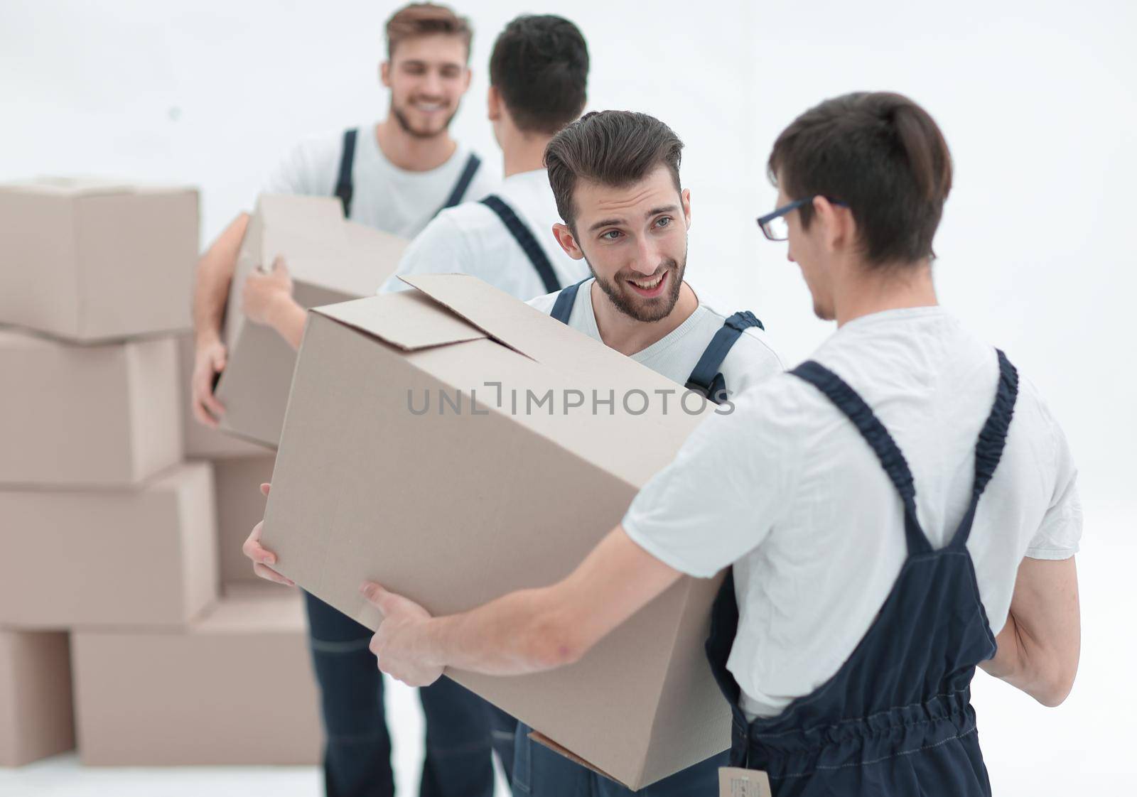 Portrait of movers holding box smiling isolated on white backgro by asdf