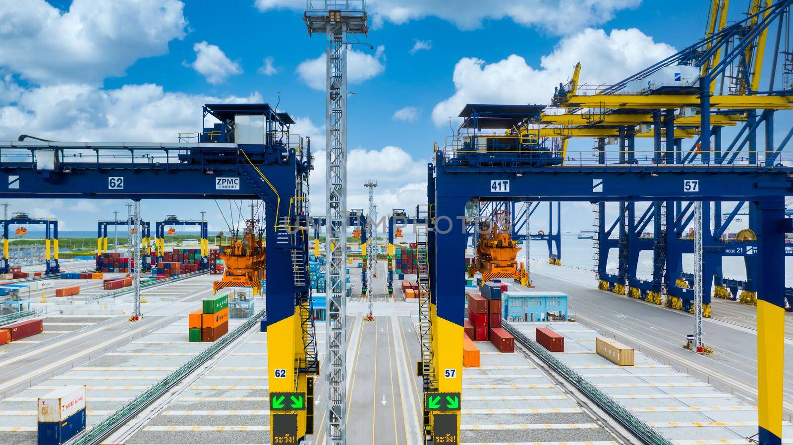 Industrial container yard with crane for business logistic import export, Crane loading cargo container to container ship in the international terminal yard container depot sea port freight shipping. by AvigatoR